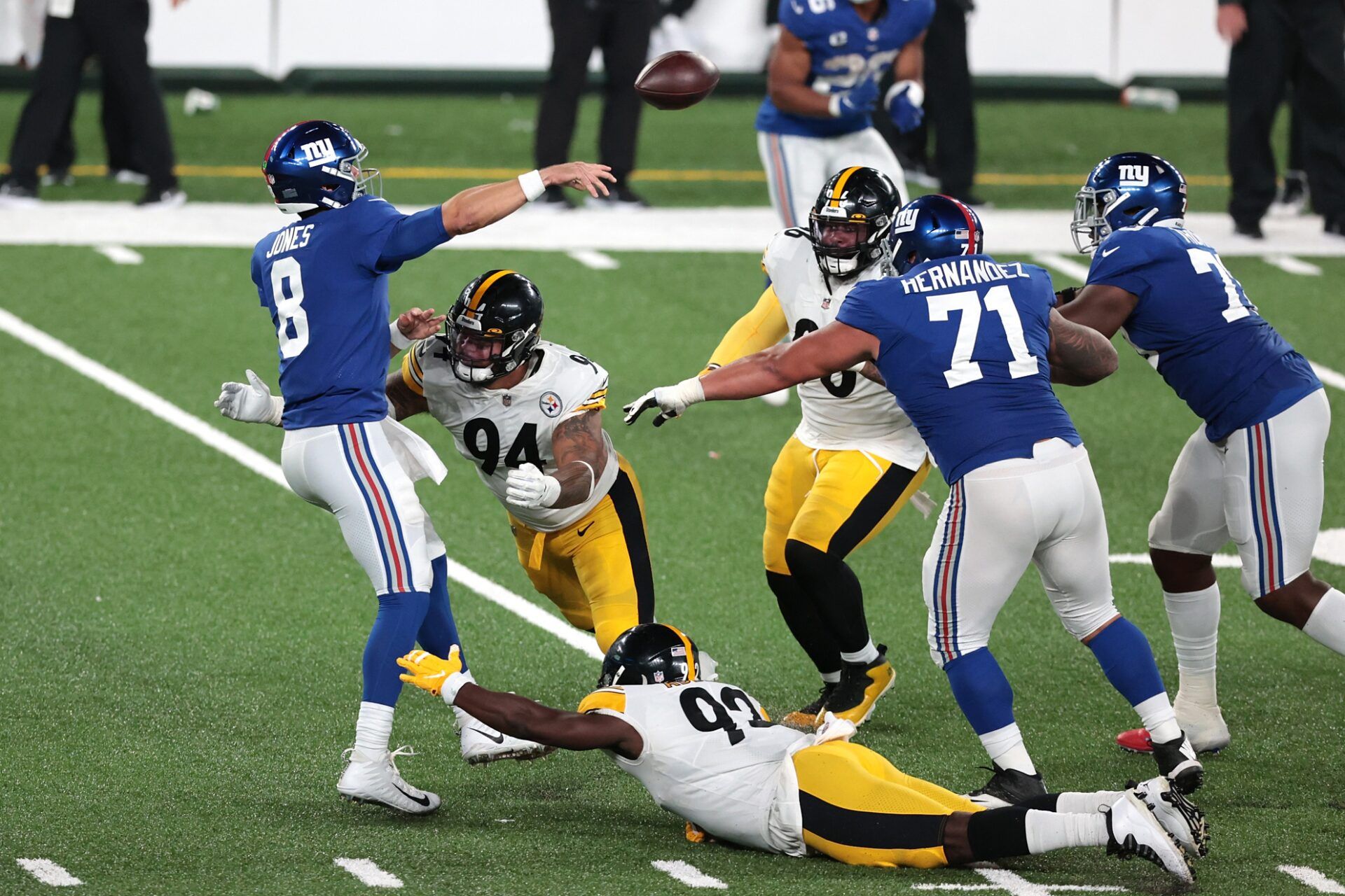 New York Giants quarterback Daniel Jones (8) throws the ball as a94 and defensive tackle Dan McCullers (93) tackle during the second half at MetLife Stadium.