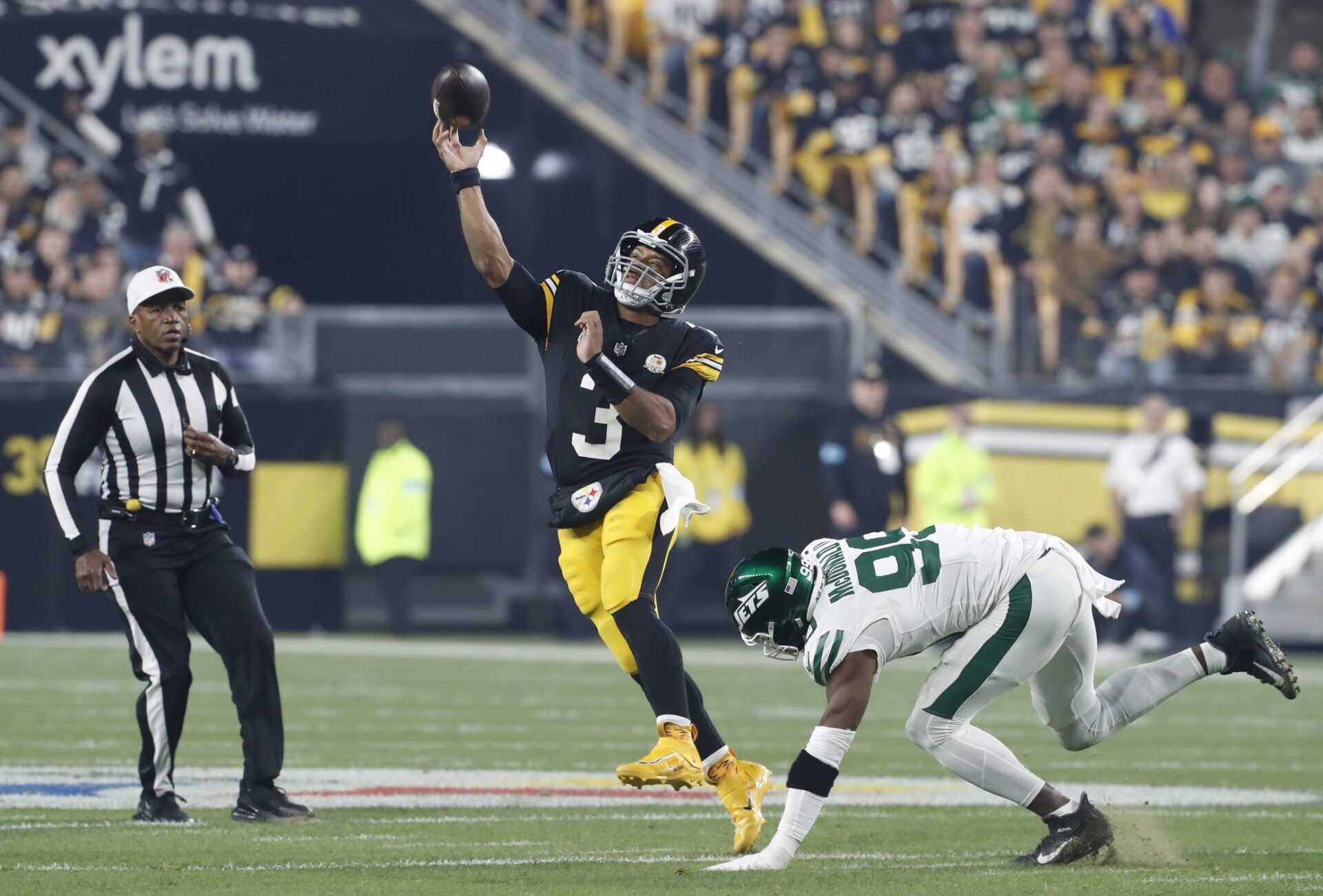 Pittsburgh Steelers quarterback Russell Wilson (3) passes against pressure from New York Jets defensive end Will McDonald IV (99) during the first quarter at Acrisure Stadium.