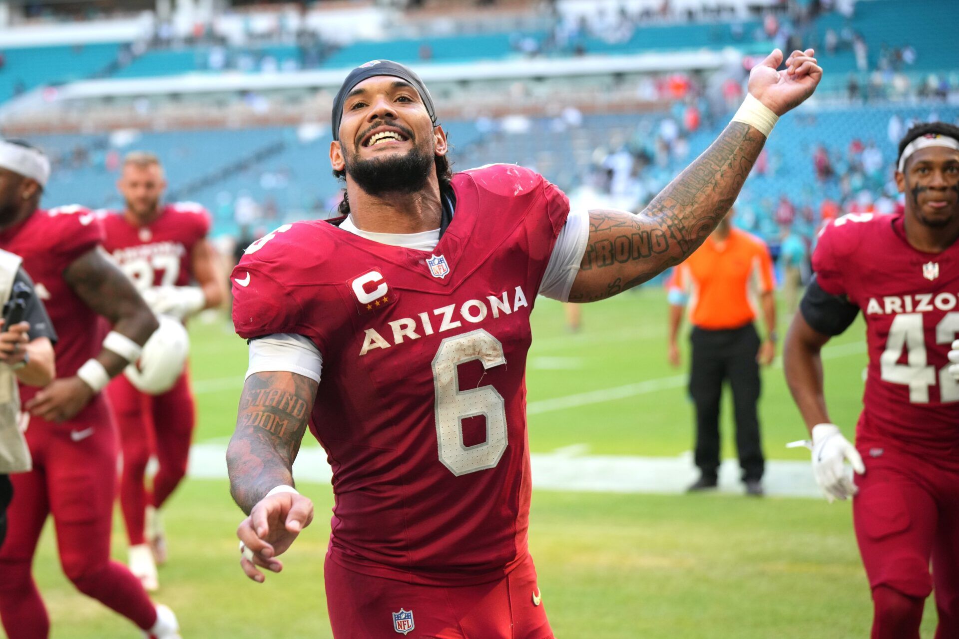 Oct 27, 2024; Miami Gardens, Florida, USA; Arizona Cardinals running back James Conner (6) celebrates the win against the Miami Dolphins with fans at Hard Rock Stadium. Mandatory Credit: Jim Rassol-Imagn Images