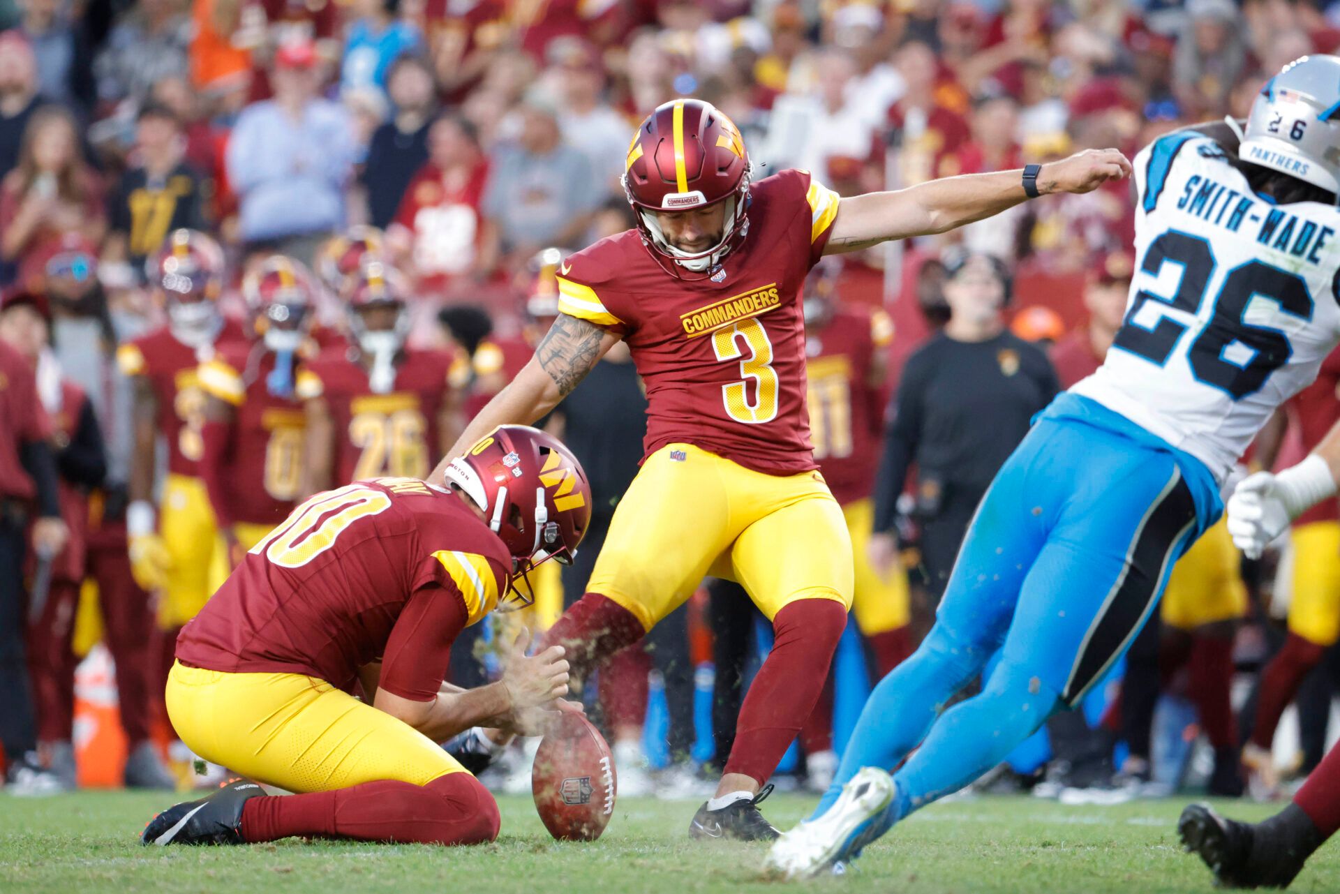 Oct 20, 2024; Landover, Maryland, USA; Washington Commanders place kicker Austin Seibert (3) kicks a field goal as Commanders punter Tress Way (10) holds the ball against the Carolina Panthers during the second half at Northwest Stadium. Mandatory Credit: Amber Searls-Imagn Images