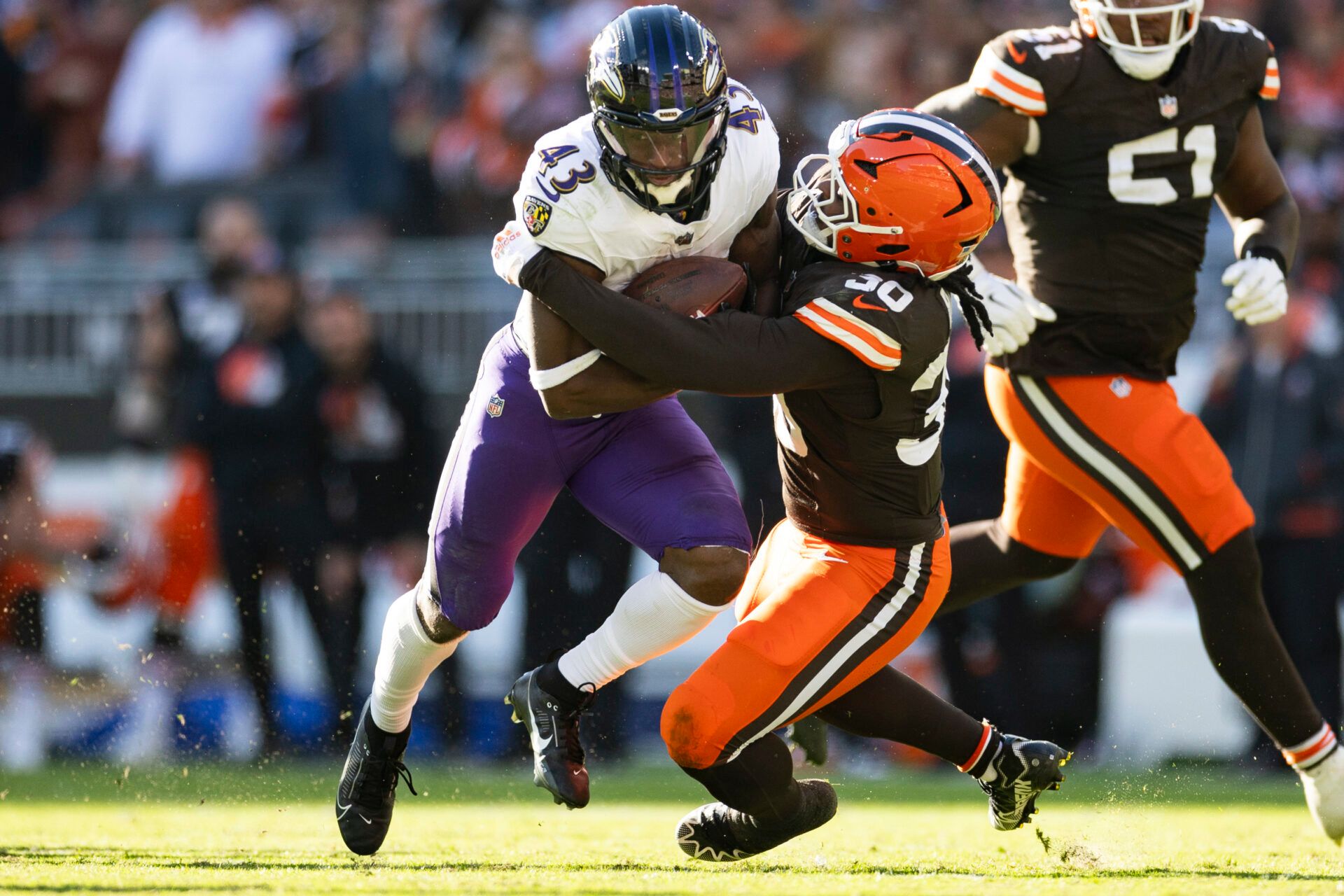 Oct 27, 2024; Cleveland, Ohio, USA; Cleveland Browns linebacker Devin Bush (30) tackles Baltimore Ravens running back Justice Hill (43) during the fourth quarter at Huntington Bank Field. Mandatory Credit: Scott Galvin-Imagn Images