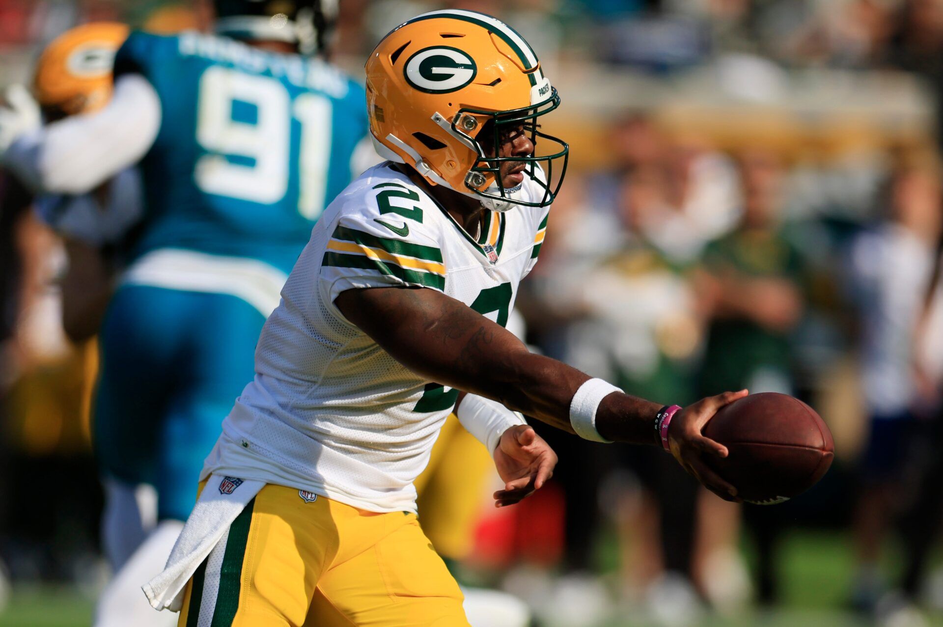 Green Bay Packers quarterback Malik Willis (2) hands off during the fourth quarter of an NFL football matchup Sunday, Oct. 27, 2024 at EverBank Stadium in Jacksonville, Fla. The Packers edged the Jaguars 30-27 on a last-second field goal. [Corey Perrine/Florida Times-Union]