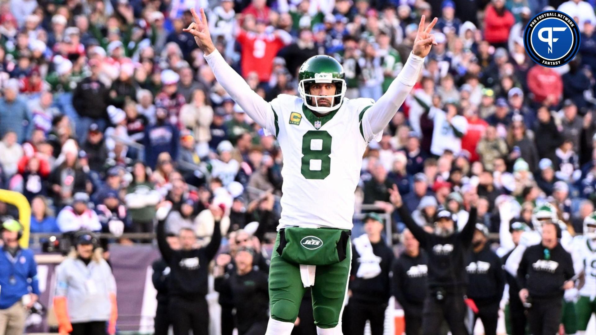 New York Jets quarterback Aaron Rodgers (8) reacts after throwing for a touchdown against the New England Patriots during the second half at Gillette Stadium.