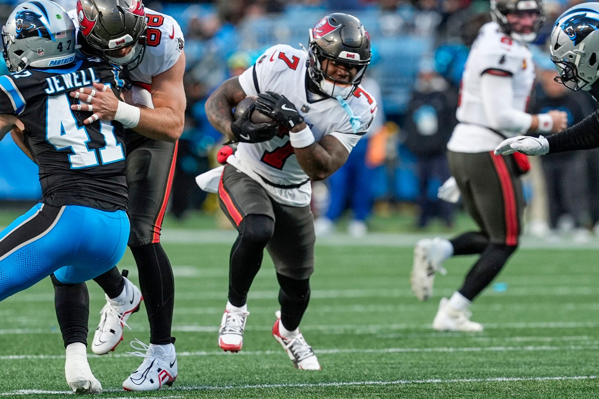 Tampa Bay Buccaneers running back Bucky Irving (7) runs for yardage against the Carolina Panthers during the first quarter at Bank of America Stadium.