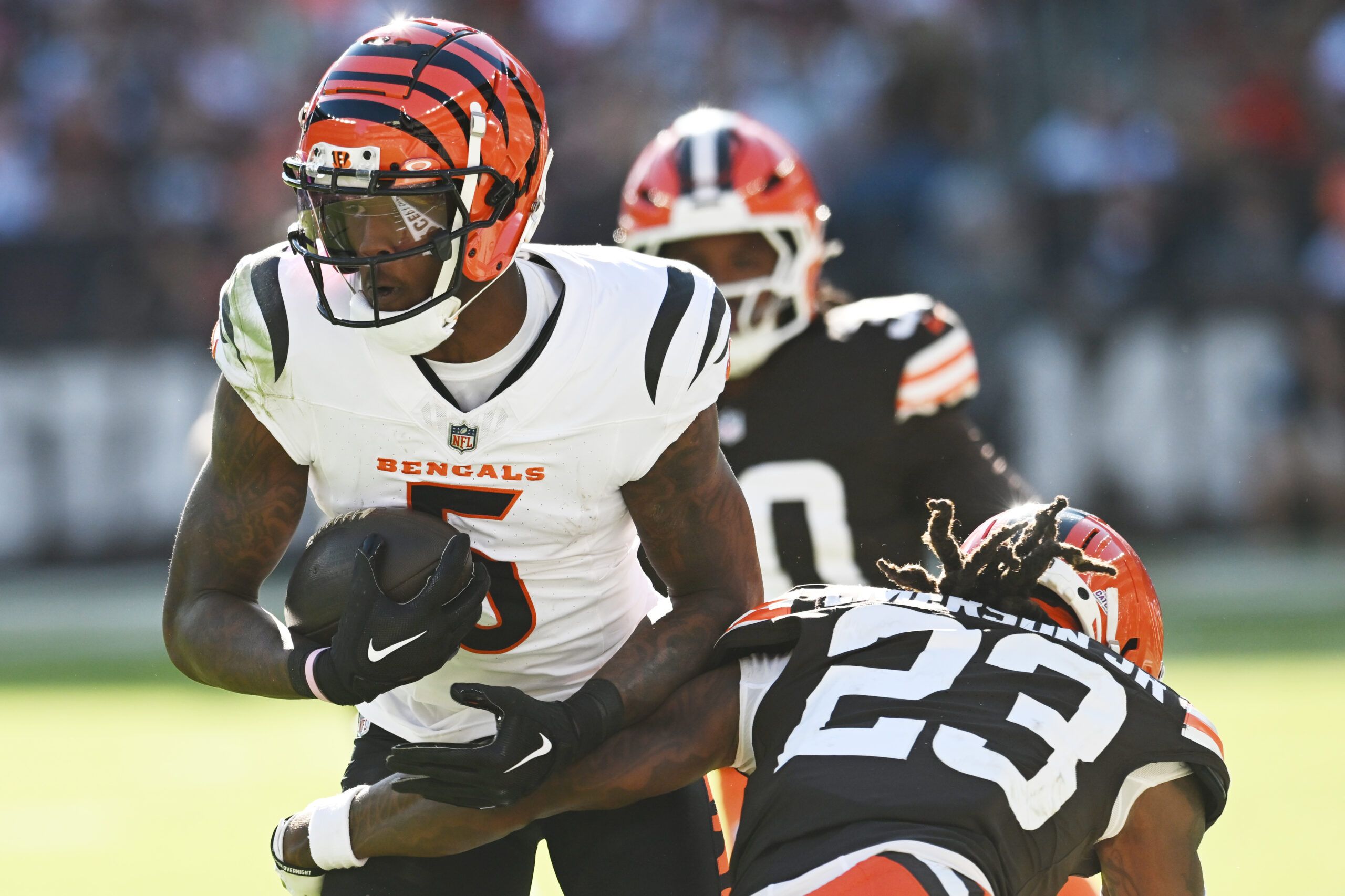 Oct 20, 2024; Cleveland, Ohio, USA; Cleveland Browns cornerback Martin Emerson Jr. (23) tackles Cincinnati Bengals wide receiver Tee Higgins (5) during the second half at Huntington Bank Field. Mandatory Credit: Ken Blaze-Imagn Images