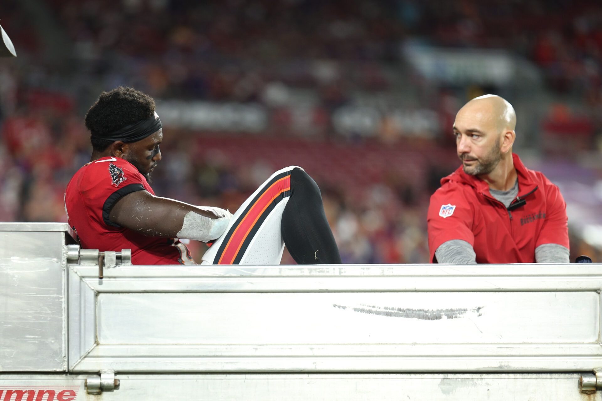 Oct 21, 2024; Tampa, Florida, USA; Tampa Bay Buccaneers wide receiver Chris Godwin (14) is carted off the field against the Baltimore Ravens in the fourth quarter at Raymond James Stadium. Mandatory Credit: Nathan Ray Seebeck-Imagn Images