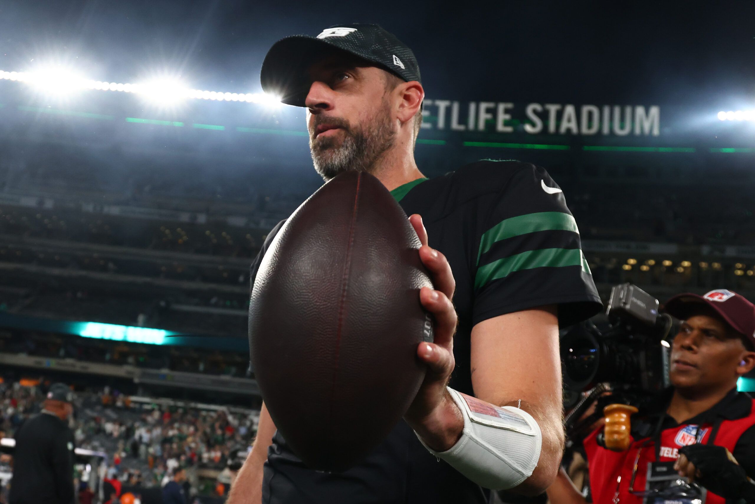 Oct 31, 2024; East Rutherford, New Jersey, USA; New York Jets quarterback Aaron Rodgers (8) walks off the field after the Jets win over the Houston Texans at MetLife Stadium. Mandatory Credit: Ed Mulholland-Imagn Images