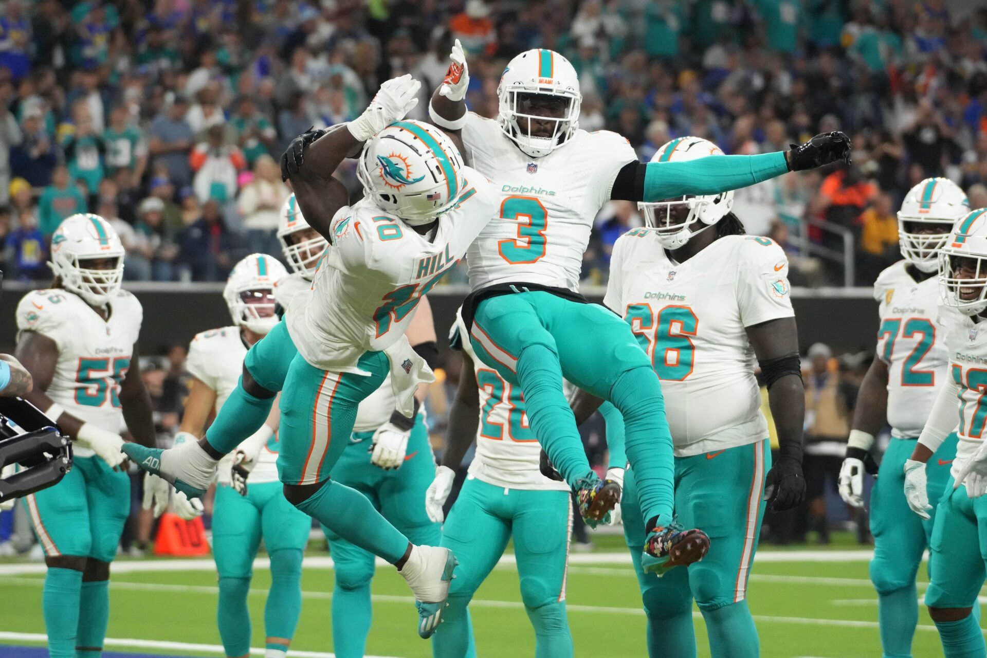 Miami Dolphins wide receiver Tyreek Hill (10) celebrates with wide receiver Odell Beckham Jr. (3) after scoring on a 1-yard touchdown reception against the Los Angeles Rams in the second half at SoFi Stadium.