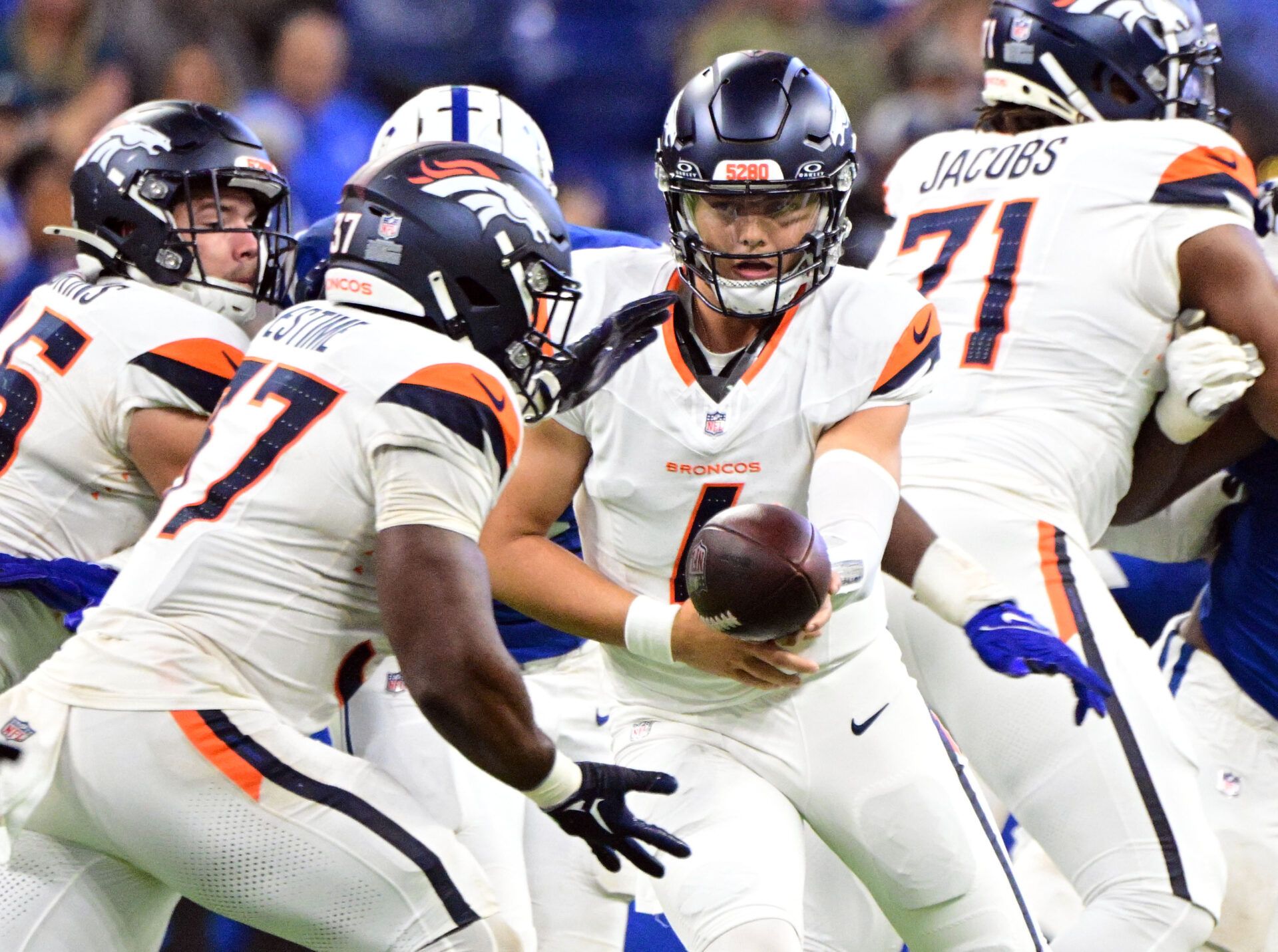 Aug 11, 2024; Indianapolis, Indiana, USA; Denver Broncos quarterback Zach Wilson (4) hands the ball off to Denver Broncos running back Audric Estime (37) during the second half at Lucas Oil Stadium. Mandatory Credit: Marc Lebryk-USA TODAY Sports