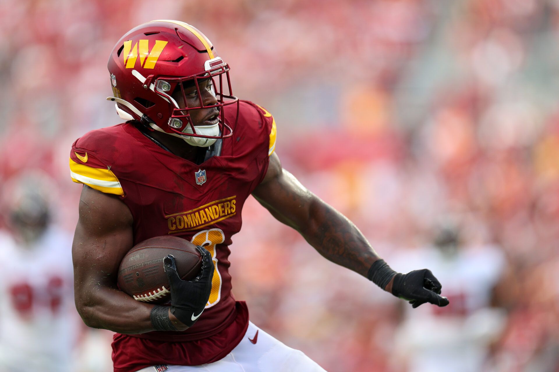 Sep 8, 2024; Tampa, Florida, USA; Washington Commanders running back Brian Robinson Jr. (8) runs with the ball against the Tampa Bay Buccaneers in the third quarter at Raymond James Stadium. Mandatory Credit: Nathan Ray Seebeck-Imagn Images