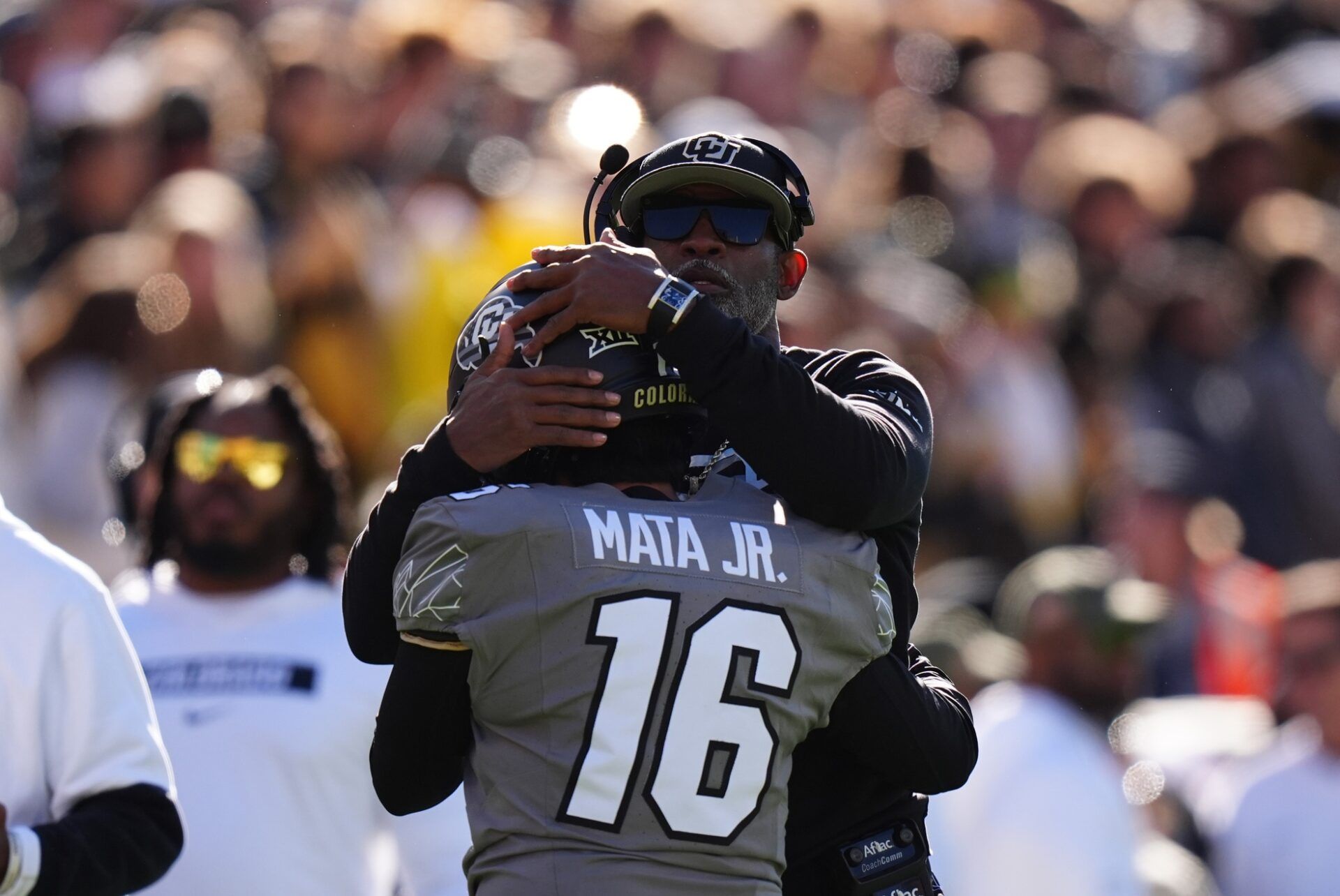 Colorado Buffaloes head coach Deion Sanders hugs Colorado Buffaloes place kicker Alejandro Mata (16) in the first quarter against the Utah Utes at Folsom Field.