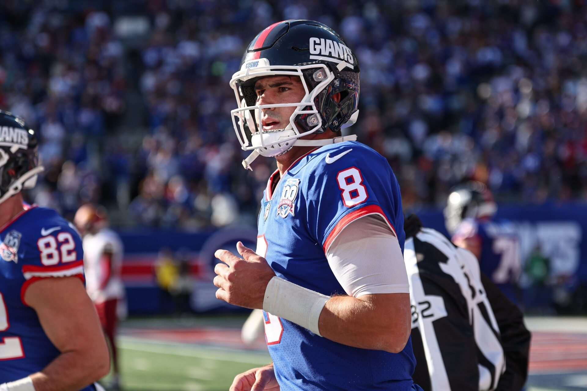 New York Giants quarterback Daniel Jones (8) runs of fetch field after throwing a touchdown pass during the first half against the Washington Commanders at MetLife Stadium.