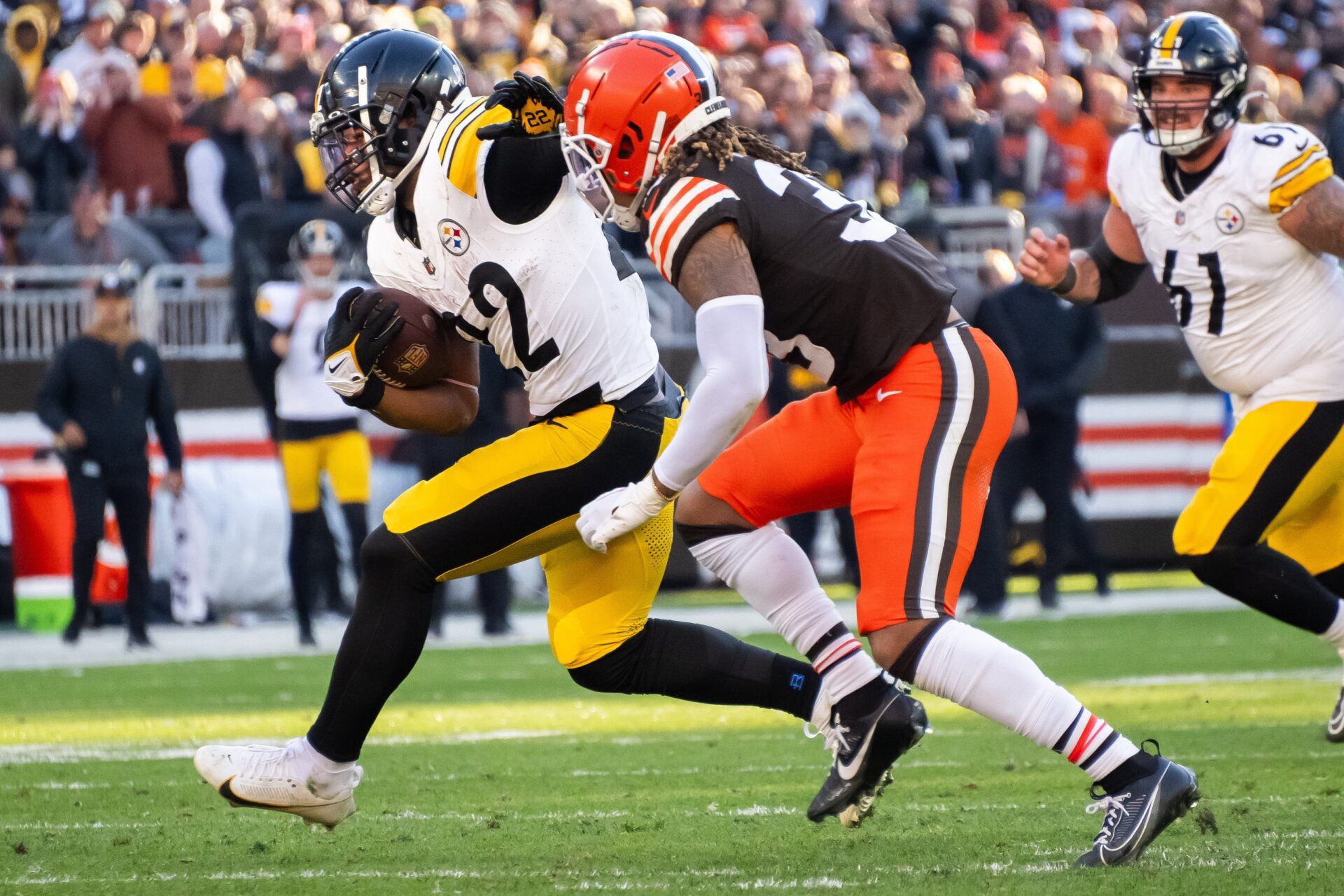 Cleveland Browns safety Ronnie Hickman (33) chases Pittsburgh Steelers running back Najee Harris (22) during the second half at Cleveland Browns Stadium.