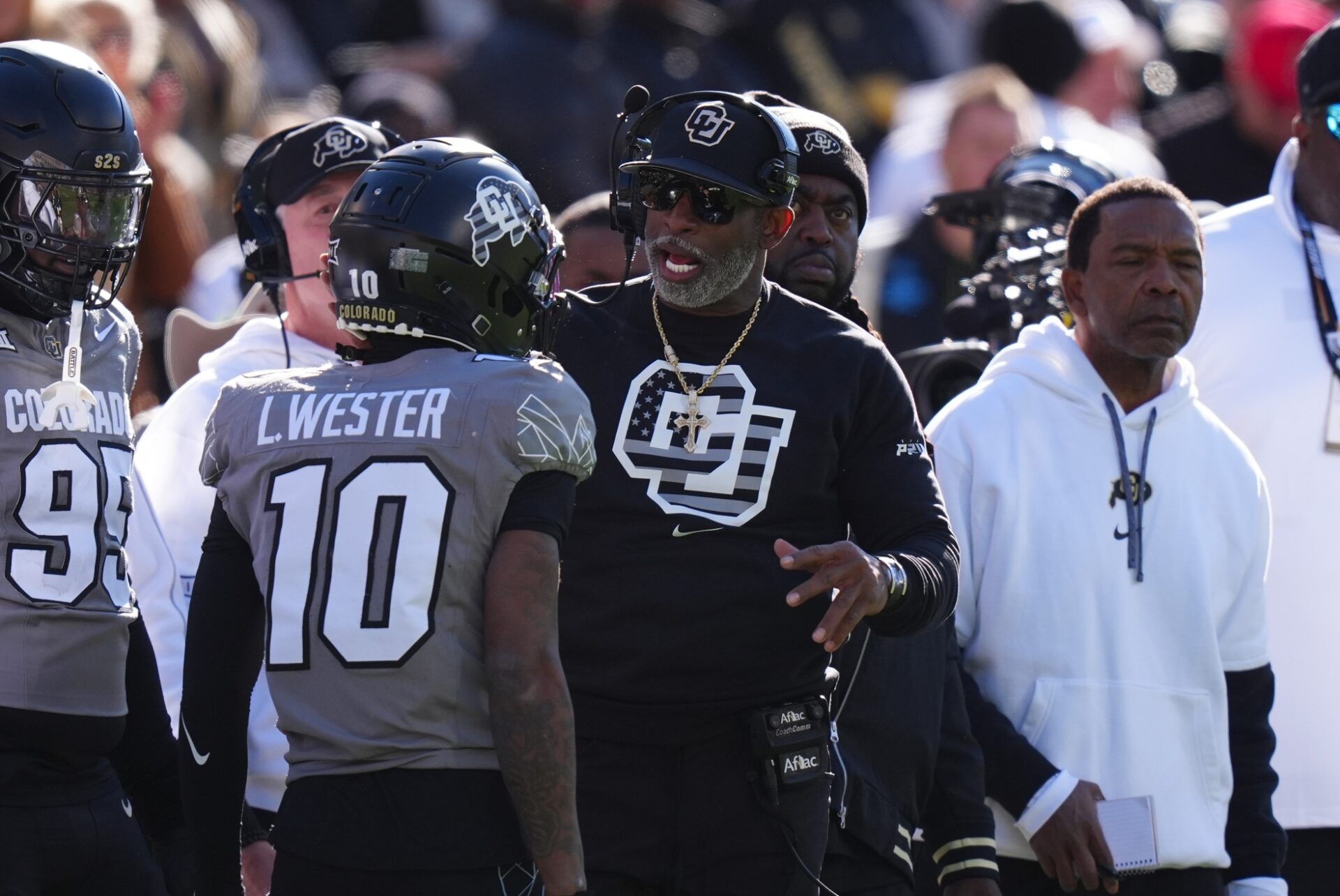 Colorado Buffaloes head coach Deion Sanders congratulates wide receiver LaJohntay Wester (10) for his punt return for a touchdown in the first quarter against the Utah Utes at Folsom Field.