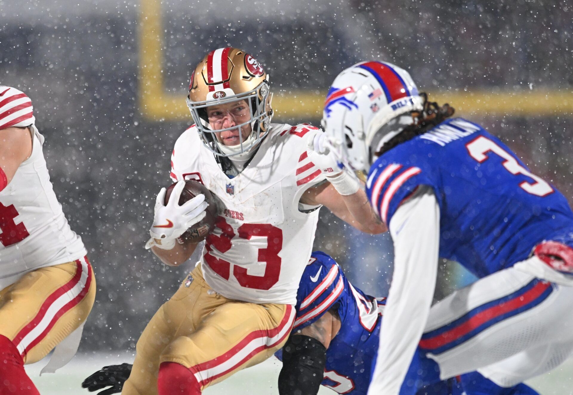 San Francisco 49ers running back Christian McCaffrey (23) tries to avoid Buffalo Bills safety Damar Hamlin (3) on a run in the first quarter at Highmark Stadium.