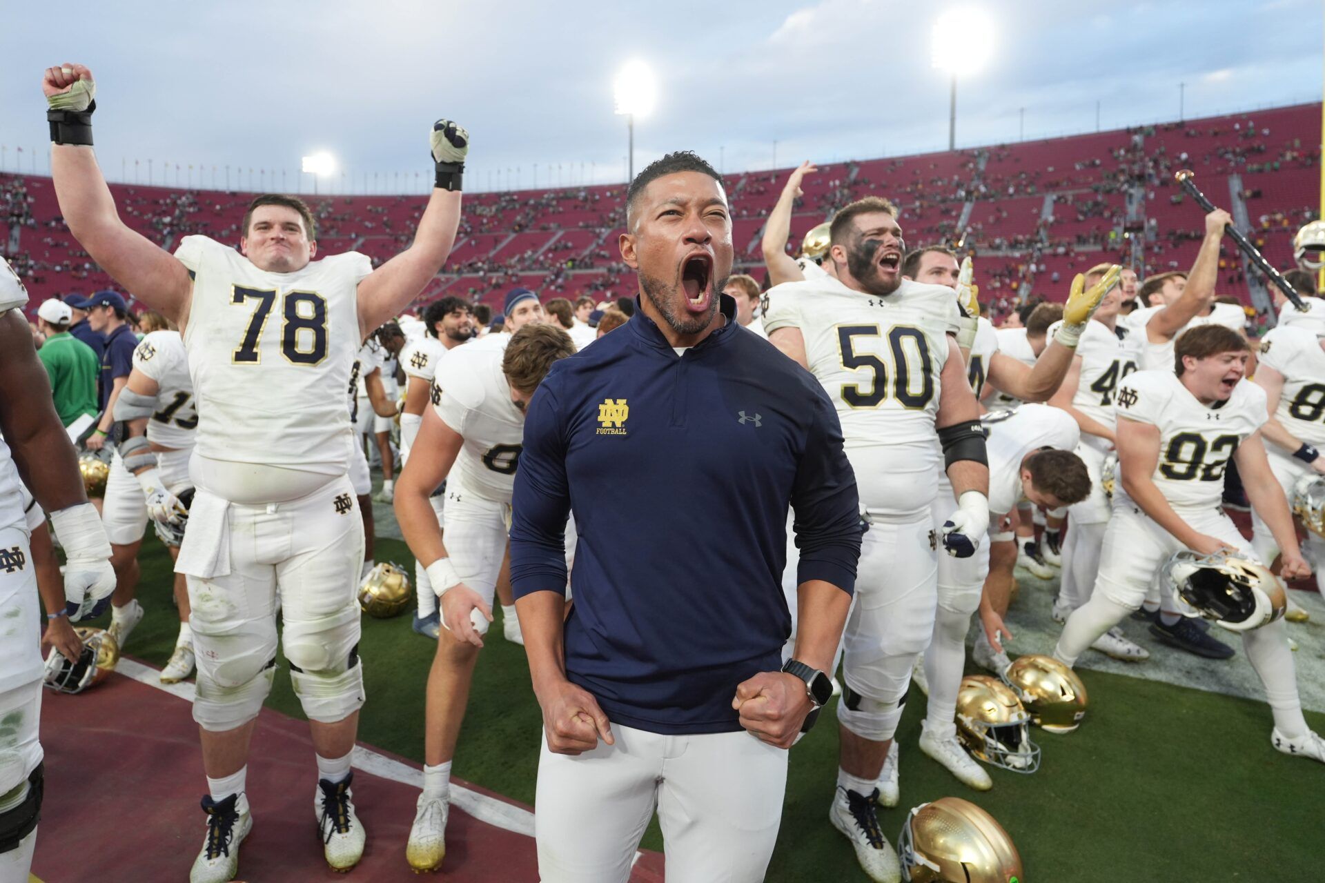 Notre Dame Fighting Irish head coach Marcus Freeman celebrates with players at the end of the game against the Southern California Trojans at United Airlines Field at Los Angeles Memorial Coliseum.