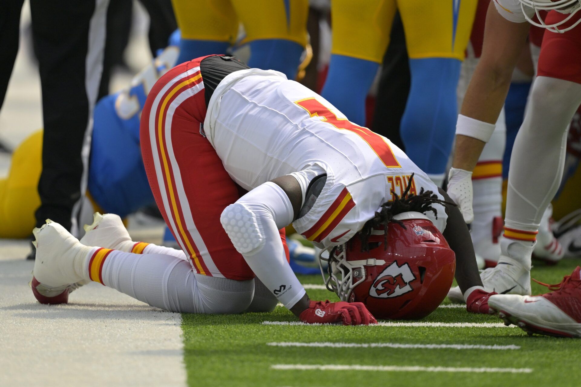 Kansas City Chiefs wide receiver Rashee Rice (4) pounds his fist on the ground after an injury in the first half against the Los Angeles Chargers at SoFi Stadium.