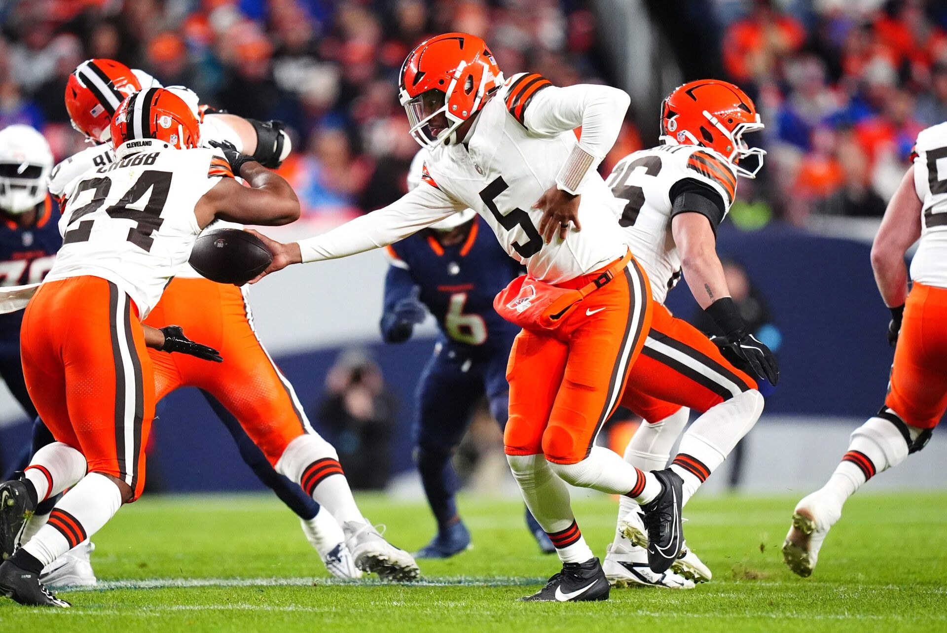 Dec 2, 2024; Denver, Colorado, USA; Cleveland Browns quarterback Jameis Winston (5) hands the ball to running back Nick Chubb (24) in the first quarter against the Denver Broncos at Empower Field at Mile High. Mandatory Credit: Ron Chenoy-Imagn Images