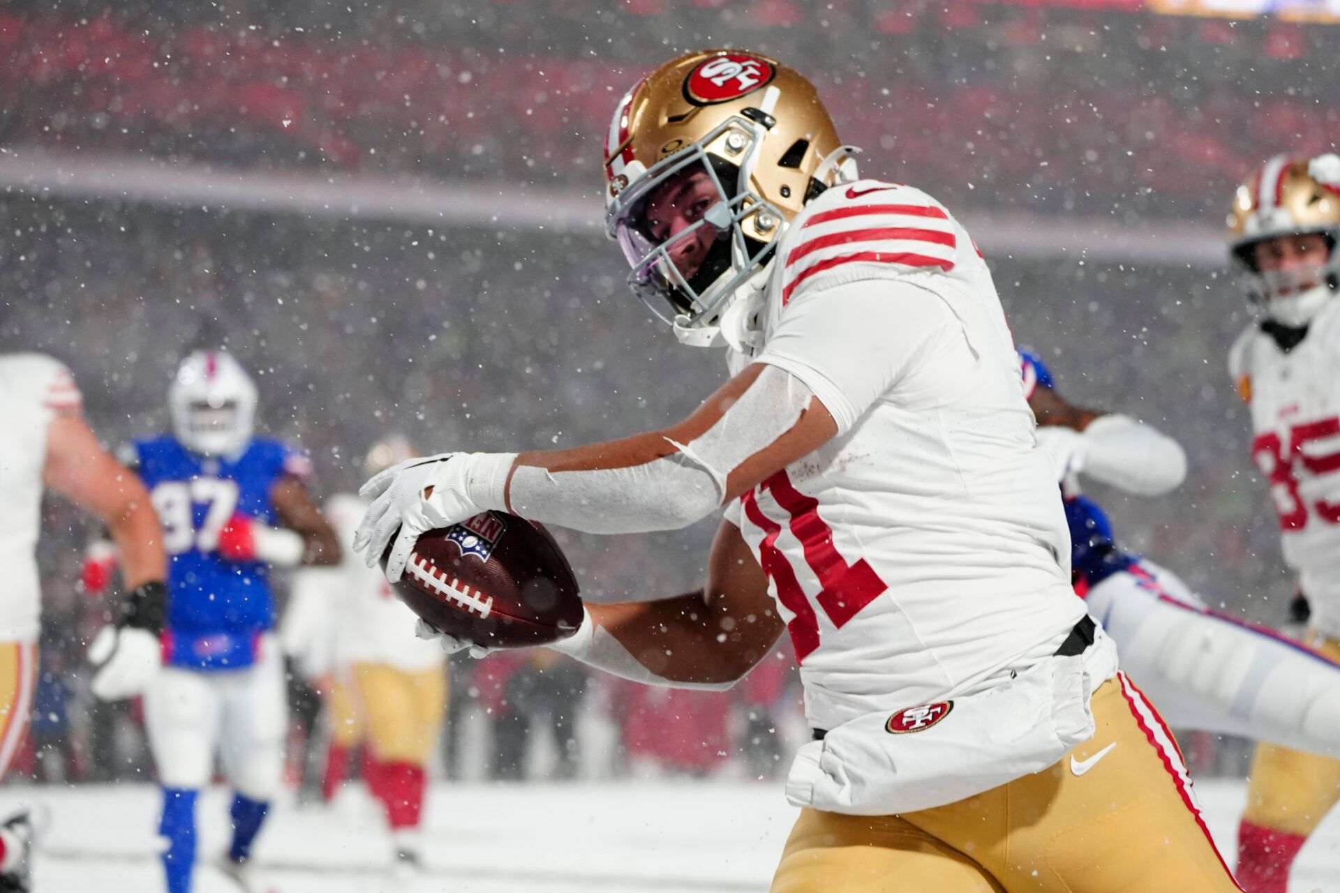 Dec 1, 2024; Orchard Park, New York, USA; San Francisco 49ers running back Isaac Guerendo (31) runs with the ball and scores a touchdown against the Buffalo Bills during the second half at Highmark Stadium. Mandatory Credit: Gregory Fisher-Imagn Images