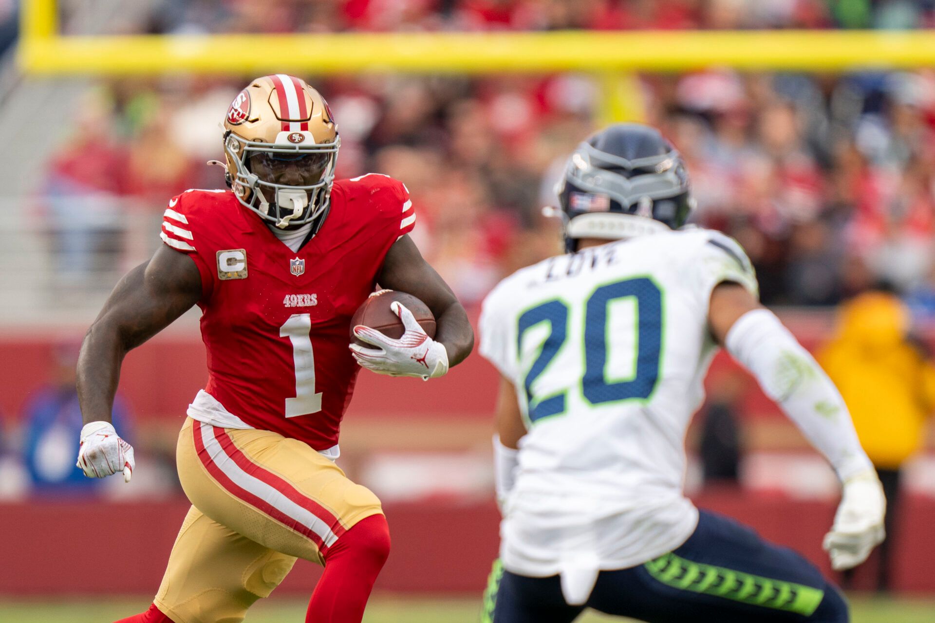 November 17, 2024; Santa Clara, California, USA; San Francisco 49ers wide receiver Deebo Samuel Sr. (1) runs the football against Seattle Seahawks safety Julian Love (20) during the fourth quarter at Levi's Stadium. Mandatory Credit: Kyle Terada-Imagn Images