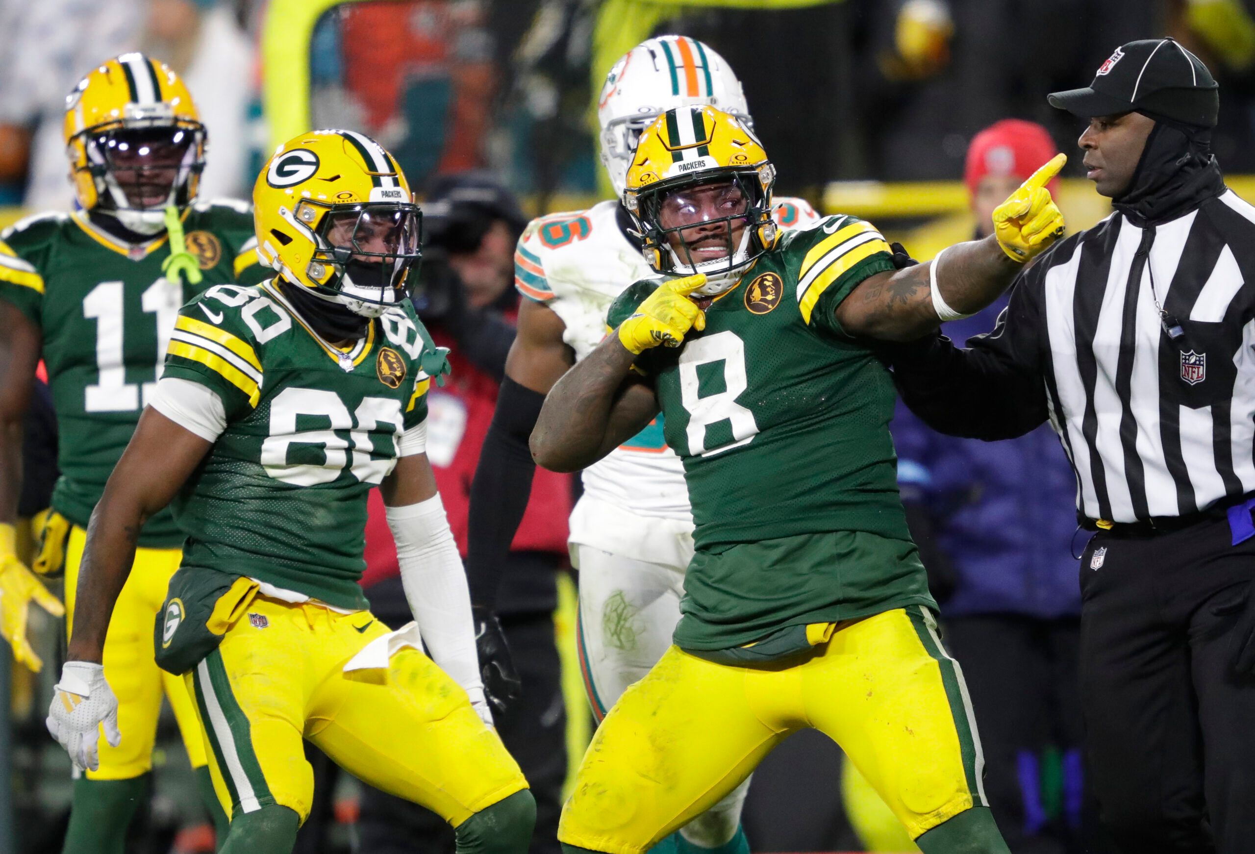 Nov 28, 2024; Green Bay, Wisconsin, USA; Green Bay Packers running back Josh Jacobs (8) celebrates after a long reception and run in the fourth quarter against the Miami Dolphins at Lambeau Field. Mandatory Credit: Dan Powers-Imagn Images