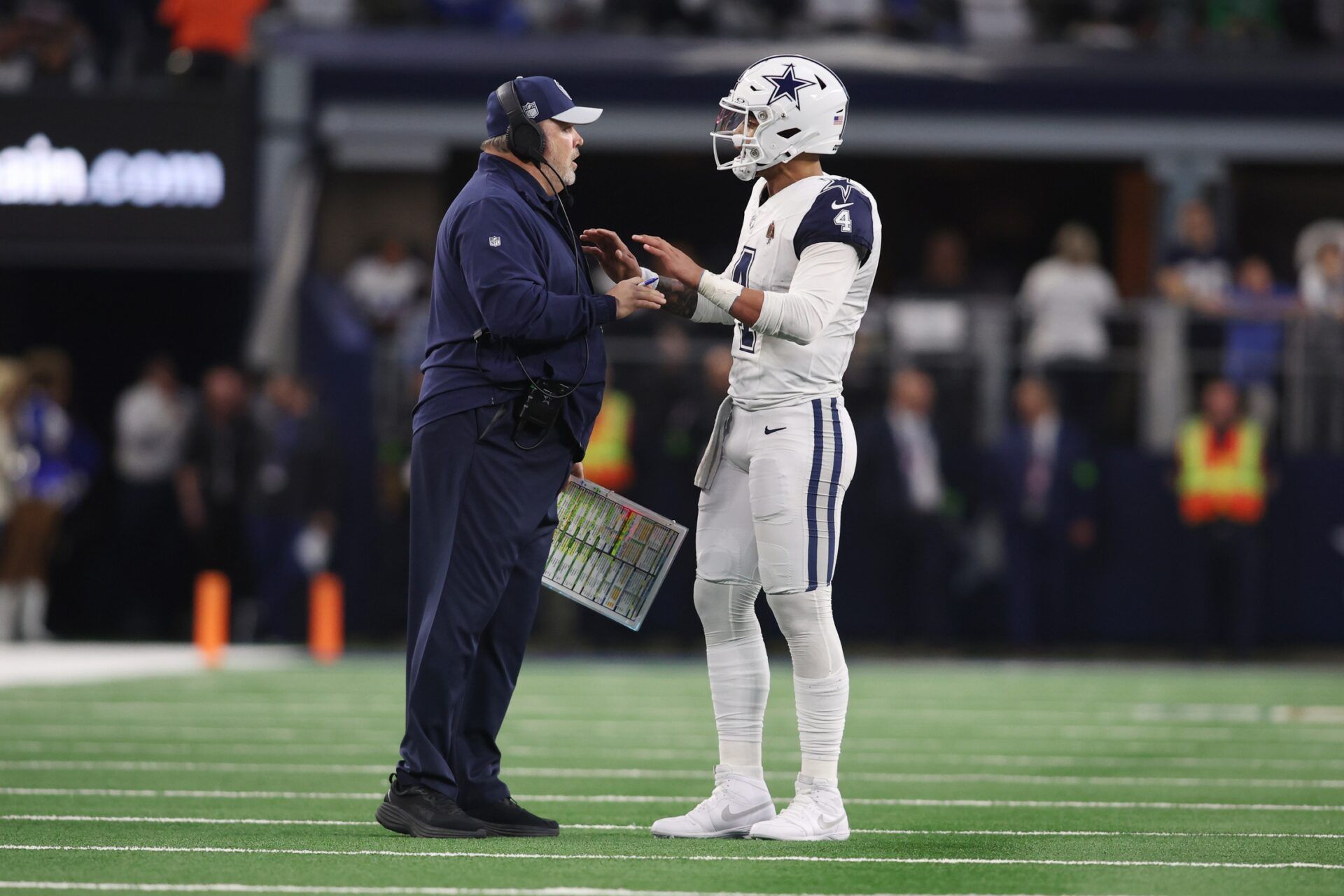 Dallas Cowboys head coach Mike McCarthy talks with quarterback Dak Prescott (4) during a timeout in the game against the Philadelphia Eagles at AT&T Stadium.