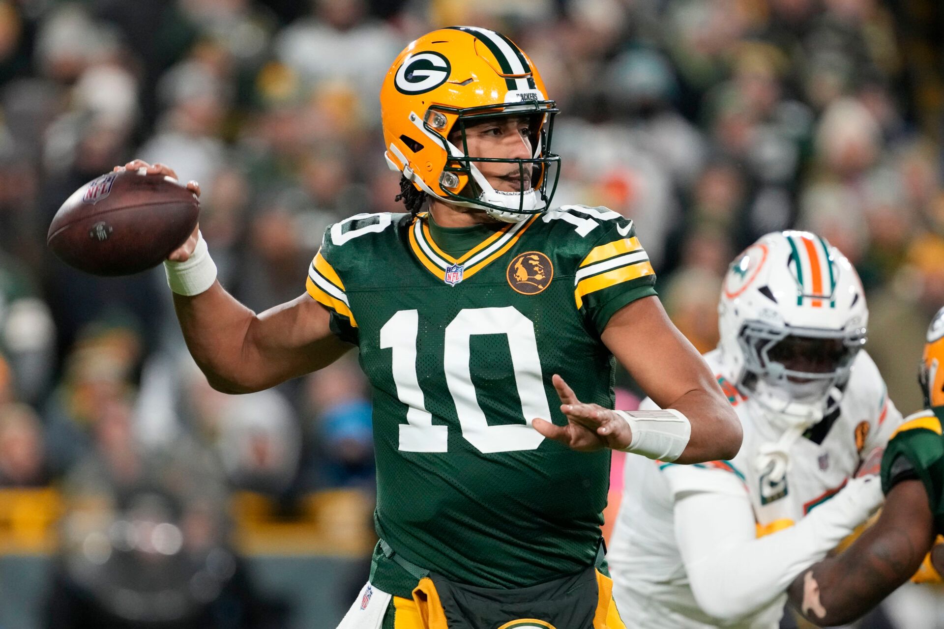 Nov 28, 2024; Green Bay, Wisconsin, USA; Green Bay Packers quarterback Jordan Love (10) throws a pass during the first quarter against the Miami Dolphins at Lambeau Field. Mandatory Credit: Jeff Hanisch-Imagn Images