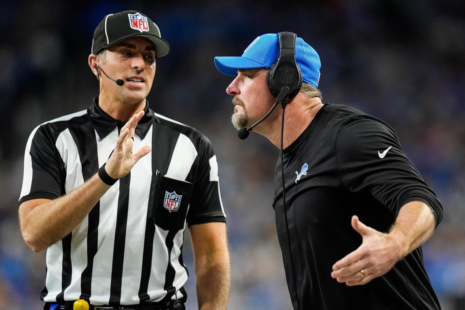 Detroit Lions head coach Dan Campbell talks to a referee regarding a call during the second half against Green Bay Packers at Ford Field in Detroit on Thursday, Dec. 5, 2024.