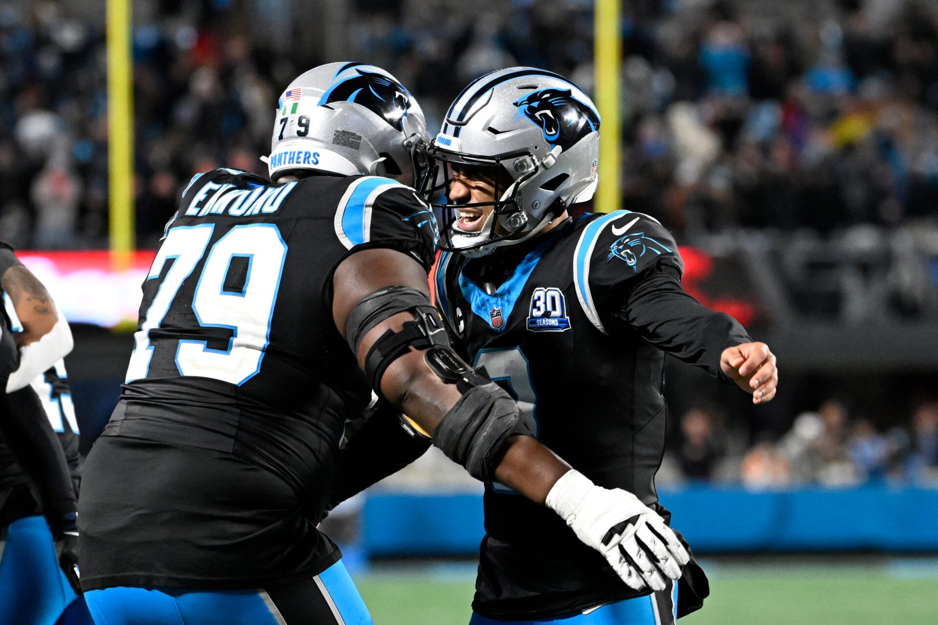 Dec 1, 2024; Charlotte, North Carolina, USA; Carolina Panthers quarterback Bryce Young (9) celebrates with offensive tackle Ikem Ekwonu (79) after the panthers score with 30 seconds left to take the lead in the fourth quarter at Bank of America Stadium. Mandatory Credit: Bob Donnan-Imagn Images