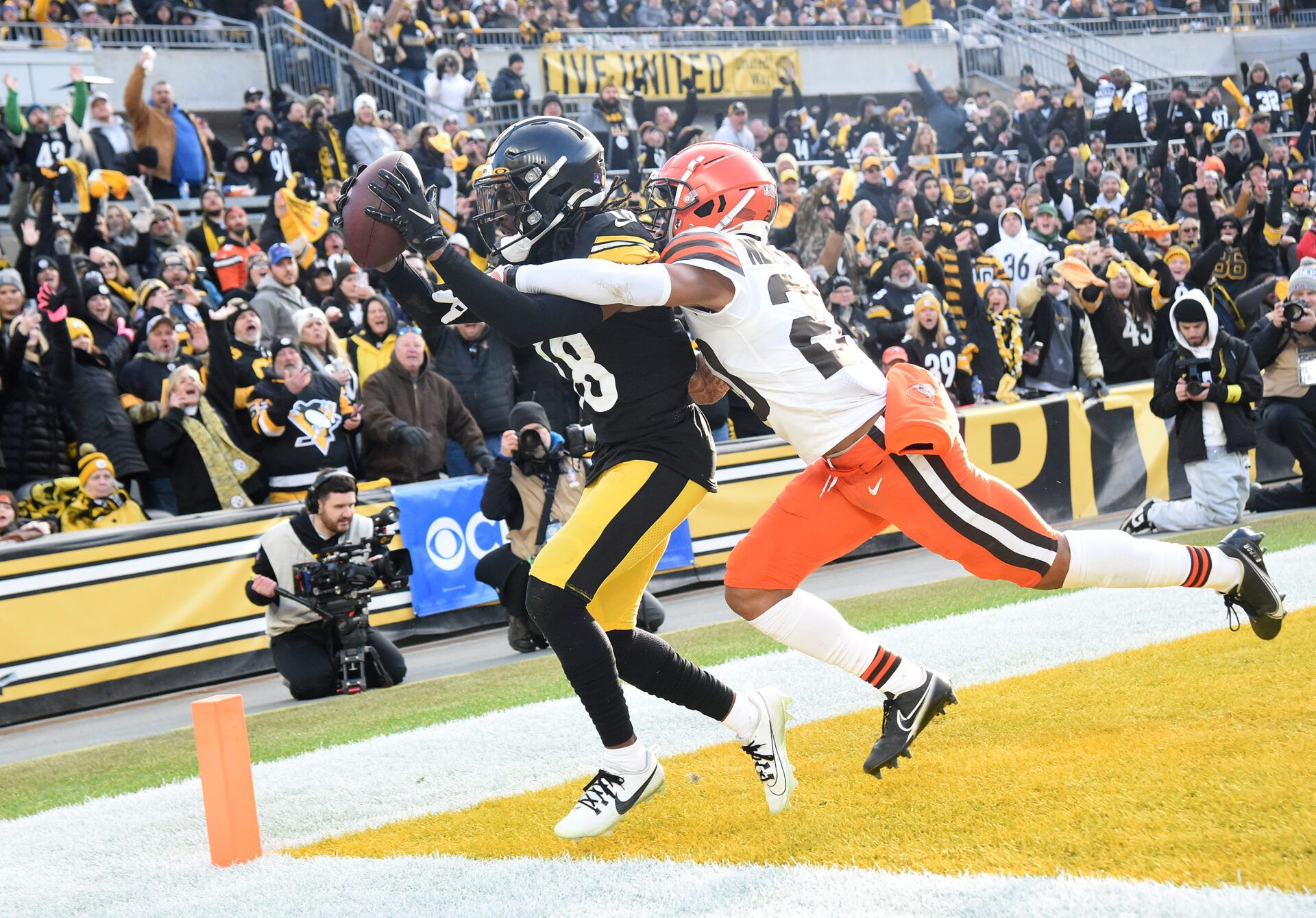 Jan 8, 2023; Pittsburgh, Pennsylvania, USA; Pittsburgh Steelers wide receiver George Pickens (18) catches a pass for a two point conversion as Cleveland Browns cornerback Greg Newsome II applies coverage during the fourth quarter at Acrisure Stadium. Mandatory Credit: Philip G. Pavely-USA TODAY Sports