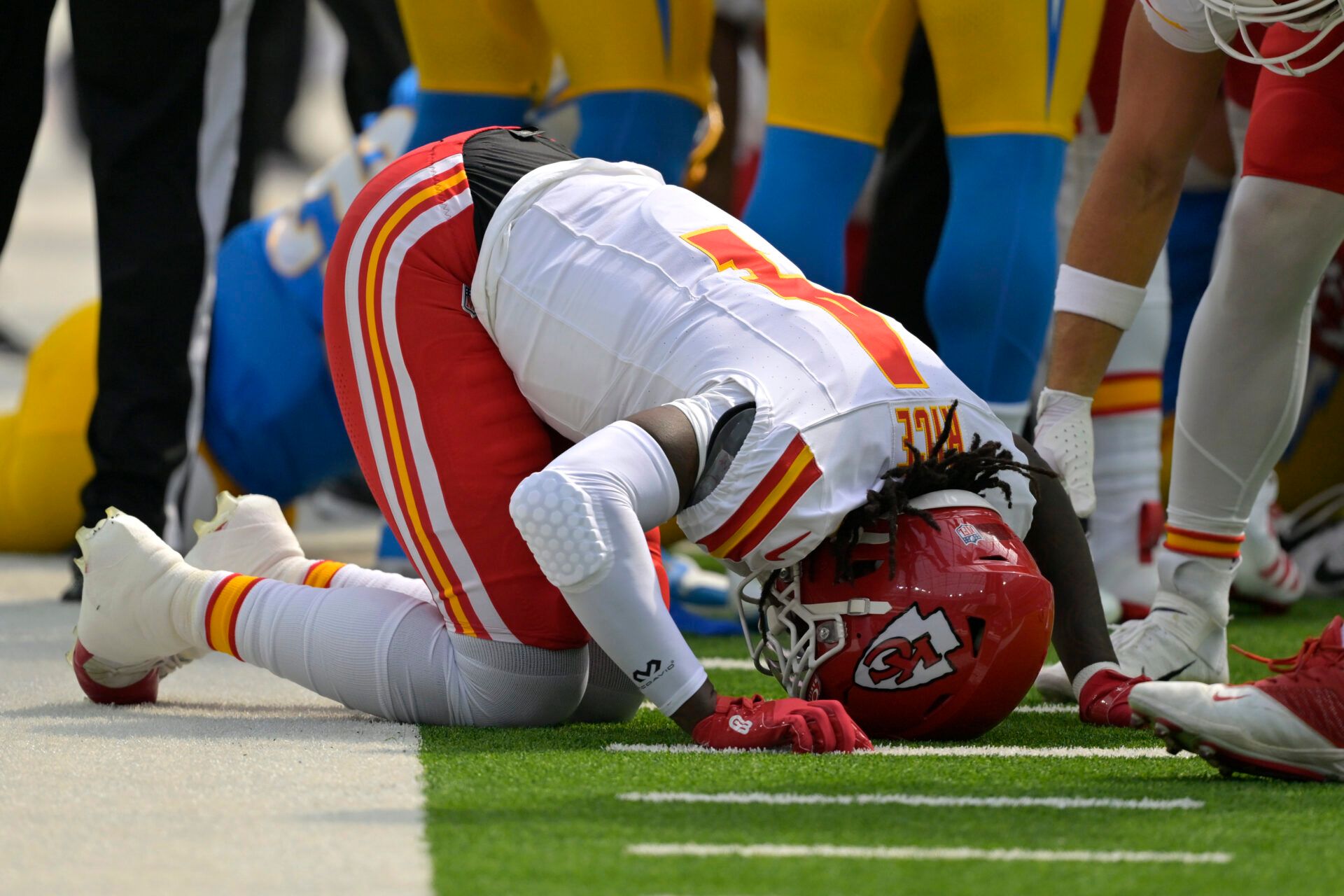 Sep 29, 2024; Inglewood, California, USA; Kansas City Chiefs wide receiver Rashee Rice (4) pounds his fist on the ground after an injury in the first half against the Los Angeles Chargers at SoFi Stadium. Mandatory Credit: Jayne Kamin-Oncea-Imagn Images