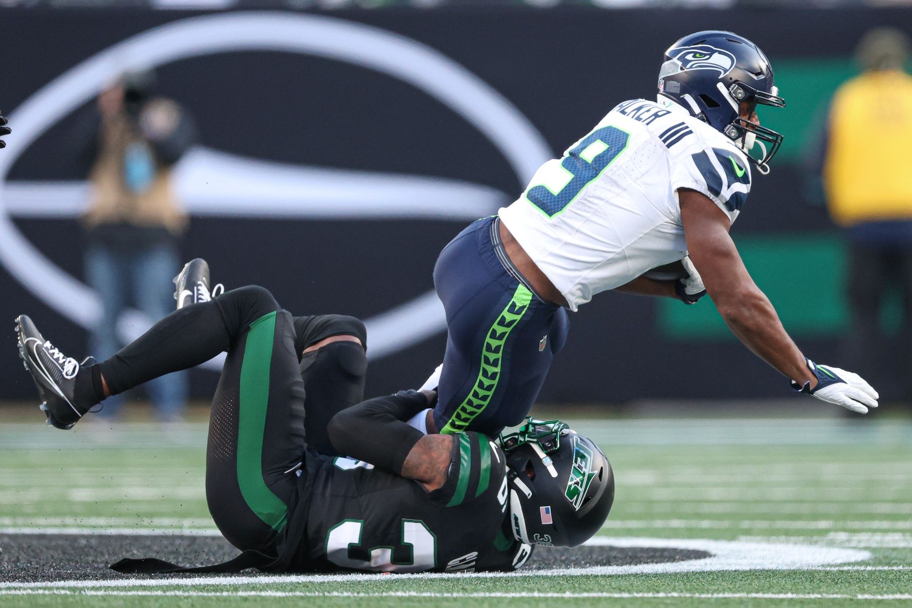 Seattle Seahawks running back Kenneth Walker III (9) is tackled by New York Jets safety Chuck Clark (36) during the second half at MetLife Stadium.