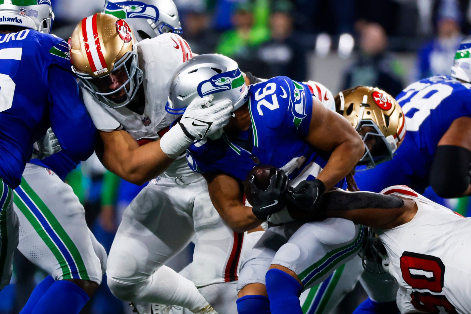 Oct 10, 2024; Seattle, Washington, USA; San Francisco 49ers defensive end Nick Bosa (97) assists on a tackle of Seattle Seahawks running back Zach Charbonnet (26) during the fourth quarter at Lumen Field. Mandatory Credit: Joe Nicholson-Imagn Images