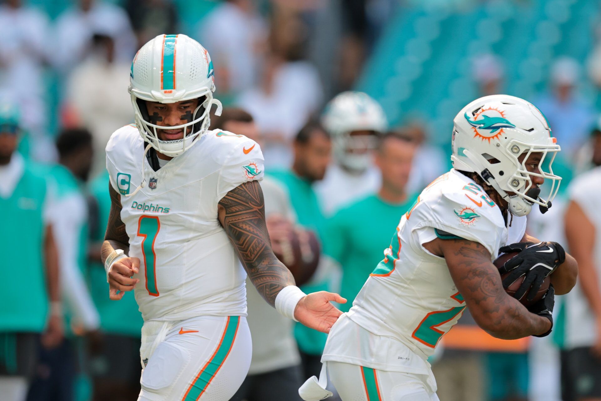 Miami Dolphins quarterback Tua Tagovailoa (1) warms up with running back Jaylen Wright (25) before the game against the New York Jets at Hard Rock Stadium.