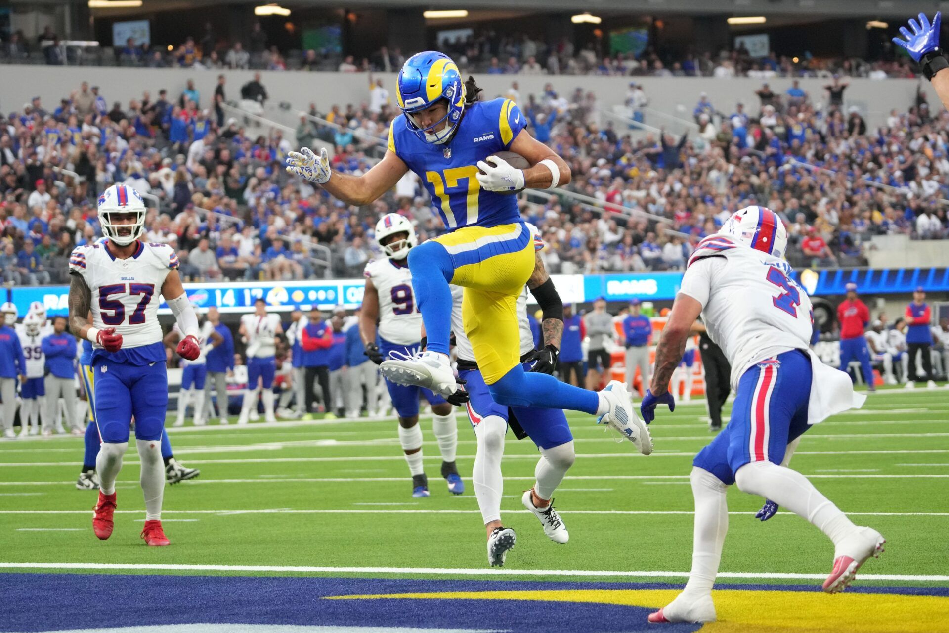 Los Angeles Rams wide receiver Puka Nacua (17) scores on a 4-yard touchdown run in the second quarter against the Buffalo Bills at SoFi Stadium.