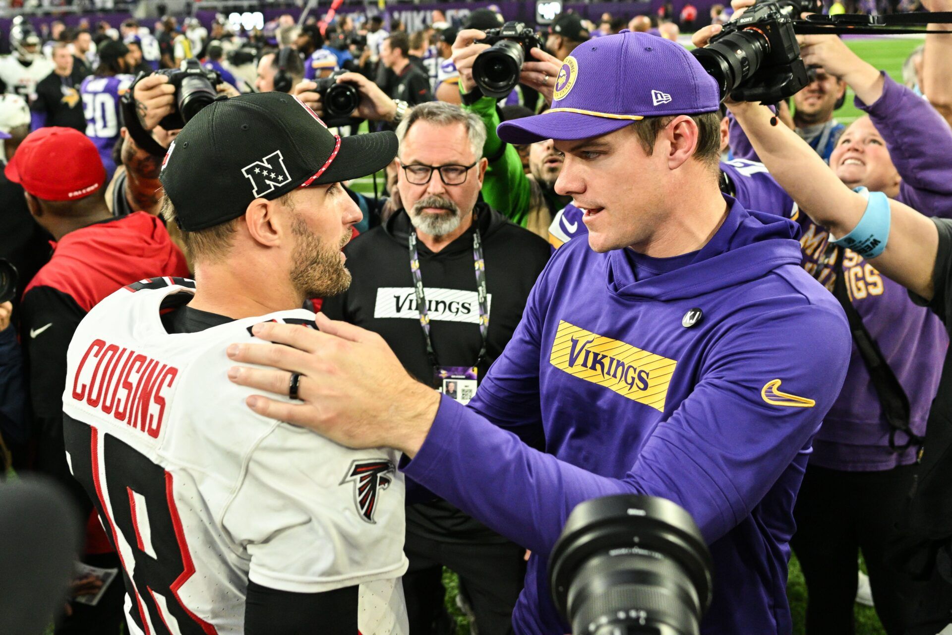 Atlanta Falcons quarterback Kirk Cousins (18) and Minnesota Vikings head coach Kevin O'Connell talk after the game at U.S. Bank Stadium.