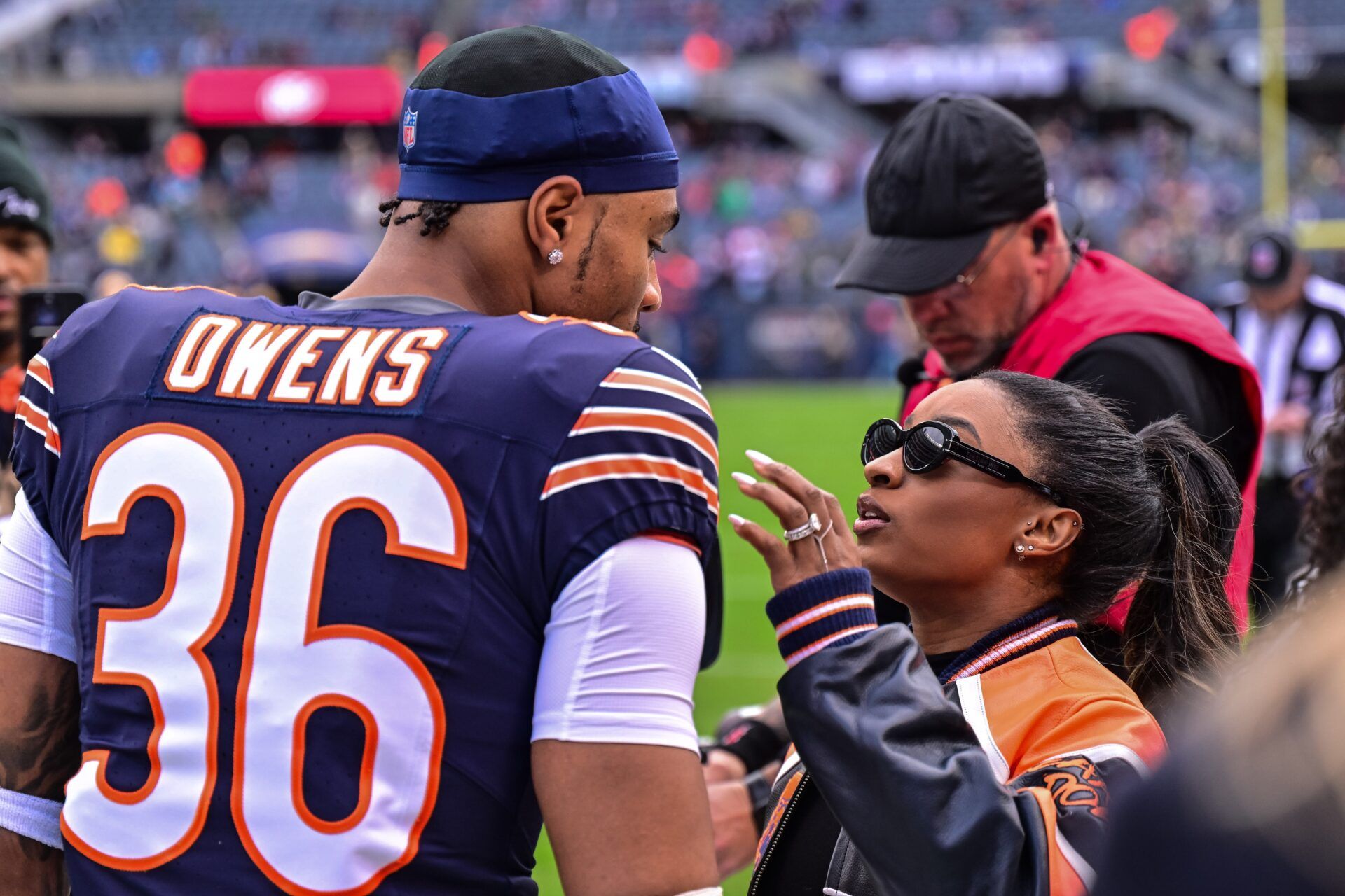 Chicago Bears defensive back Jonathan Owens (36) is greeted by wife and United States gymnast Simone Biles before the game against the Green Bay Packers at Soldier Field.