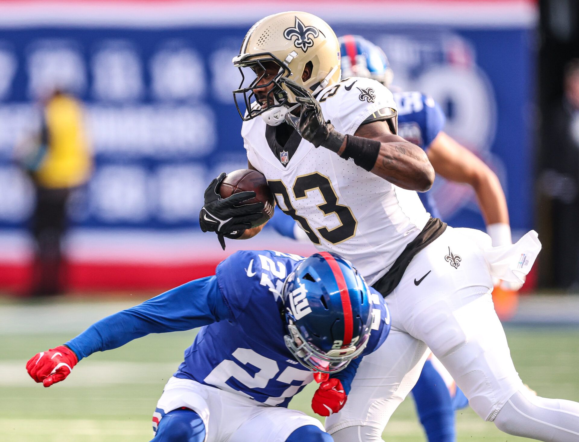 Dec 8, 2024; East Rutherford, New Jersey, USA; New Orleans Saints tight end Juwan Johnson (83) is tackled by New York Giants safety Jason Pinnock (27) during the first half at MetLife Stadium. Mandatory Credit: Vincent Carchietta-Imagn Images