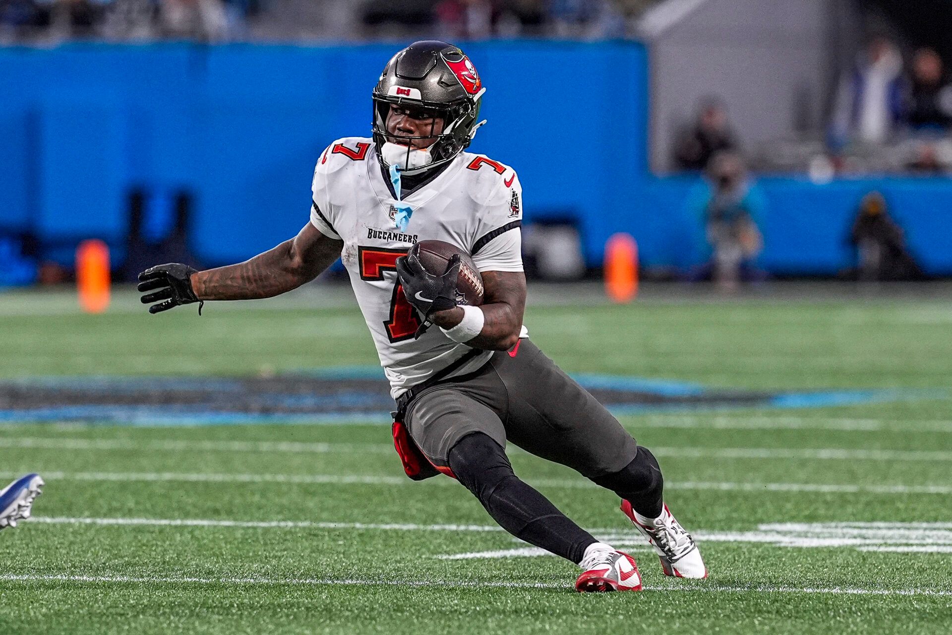 Dec 1, 2024; Charlotte, North Carolina, USA; Tampa Bay Buccaneers running back Bucky Irving (7) runs downfield against the Carolina Panthers during the second quarter at Bank of America Stadium. Mandatory Credit: Jim Dedmon-Imagn Images