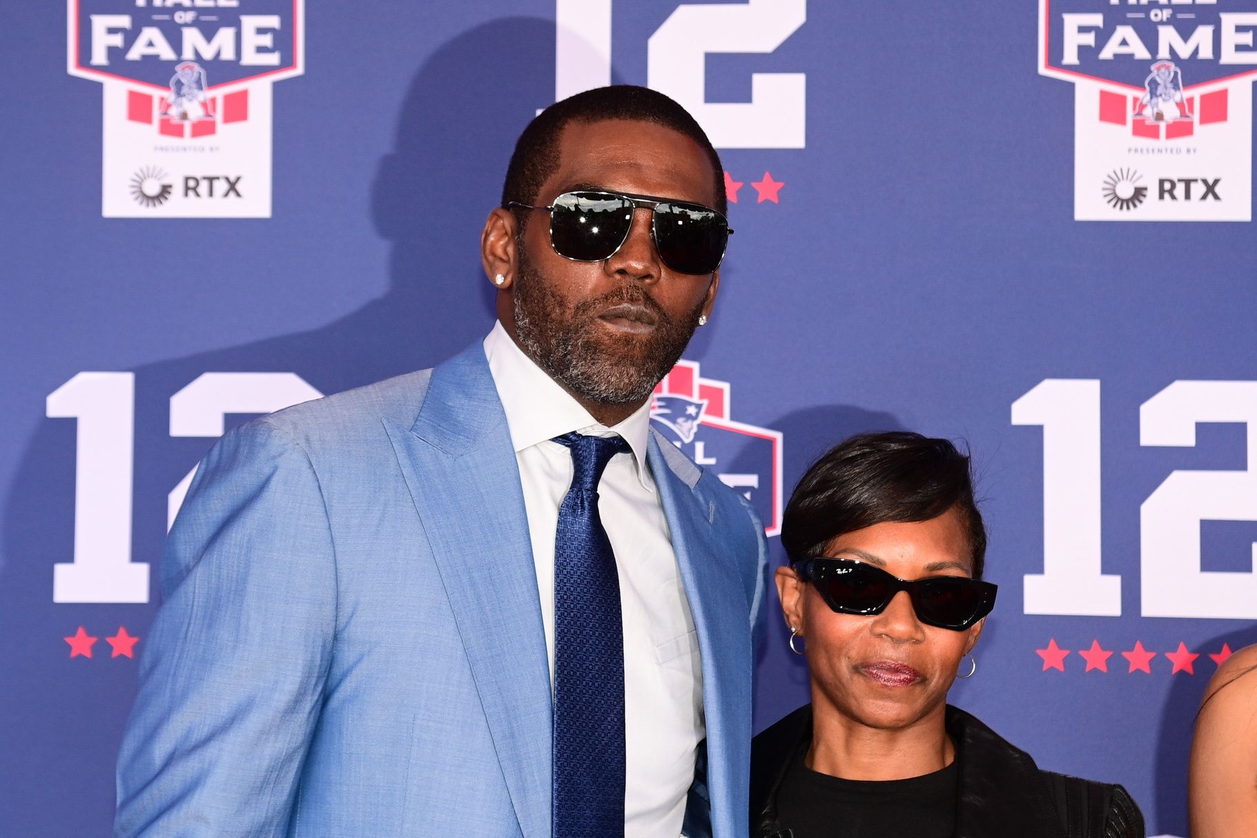 Former NFL player Randy Moss poses with his wife Lydia Griffith for a photo at the New England Patriots Hall of Fame induction ceremony for Tom Brady at Gillette Stadium.