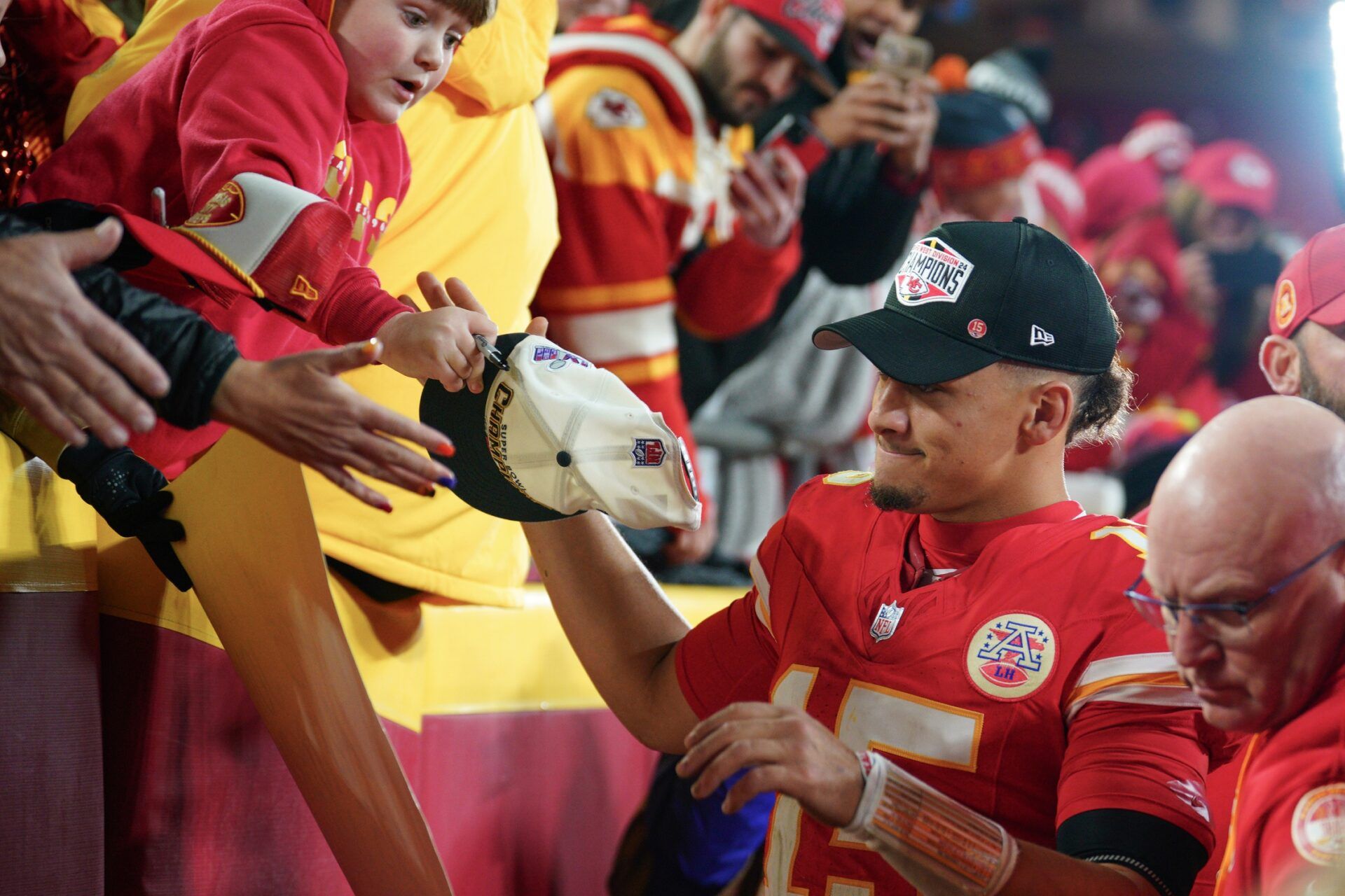 Kansas City Chiefs quarterback Patrick Mahomes (15) greets fans while leaving the field after the win over the Los Angeles Chargers at GEHA Field at Arrowhead Stadium.