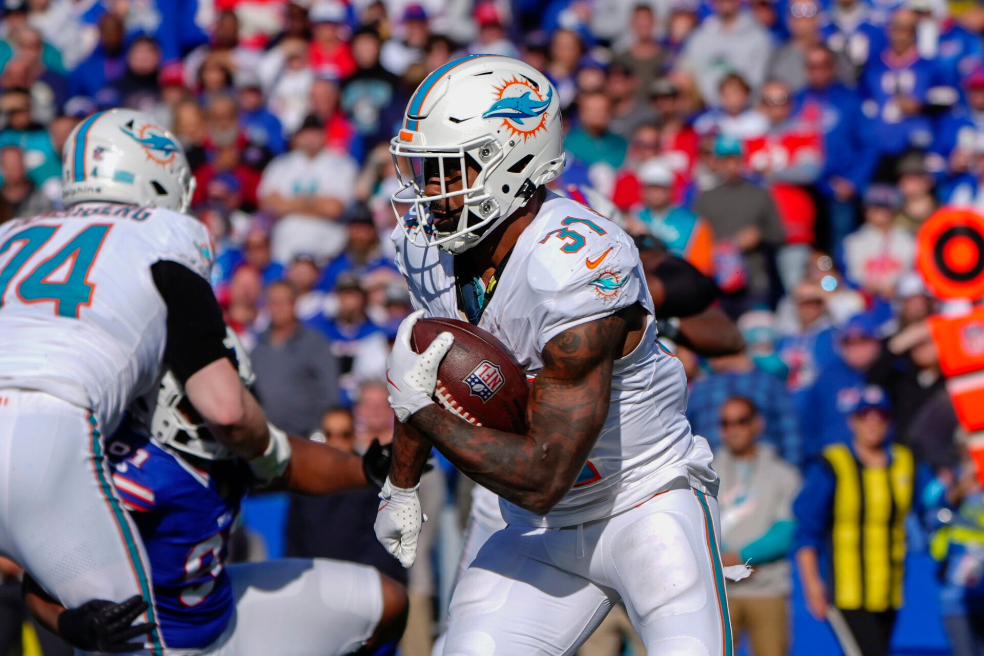 Nov 3, 2024; Orchard Park, New York, USA; Miami Dolphins running back Raheem Mostert (31) runs with the ball against the Buffalo Bills during the first half at Highmark Stadium. Mandatory Credit: Gregory Fisher-Imagn Images