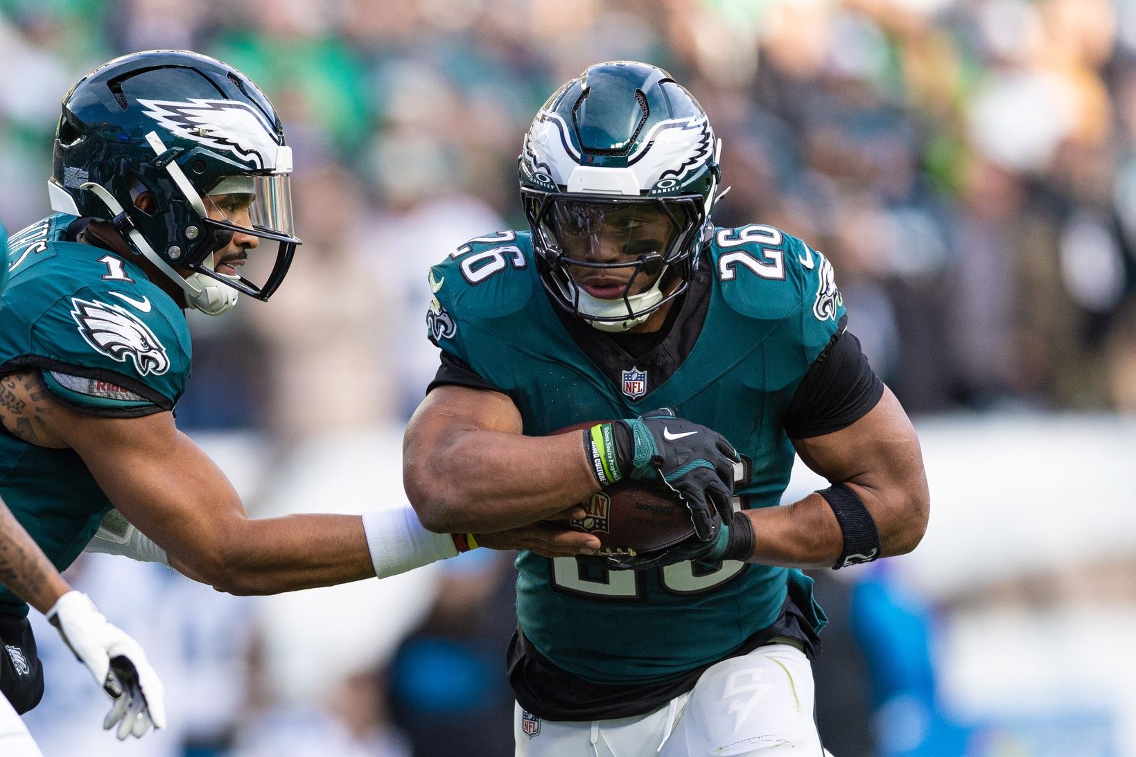 Philadelphia Eagles quarterback Jalen Hurts (1) hands off to running back Saquon Barkley (26) during the third quarter against the Carolina Panthers at Lincoln Financial Field.