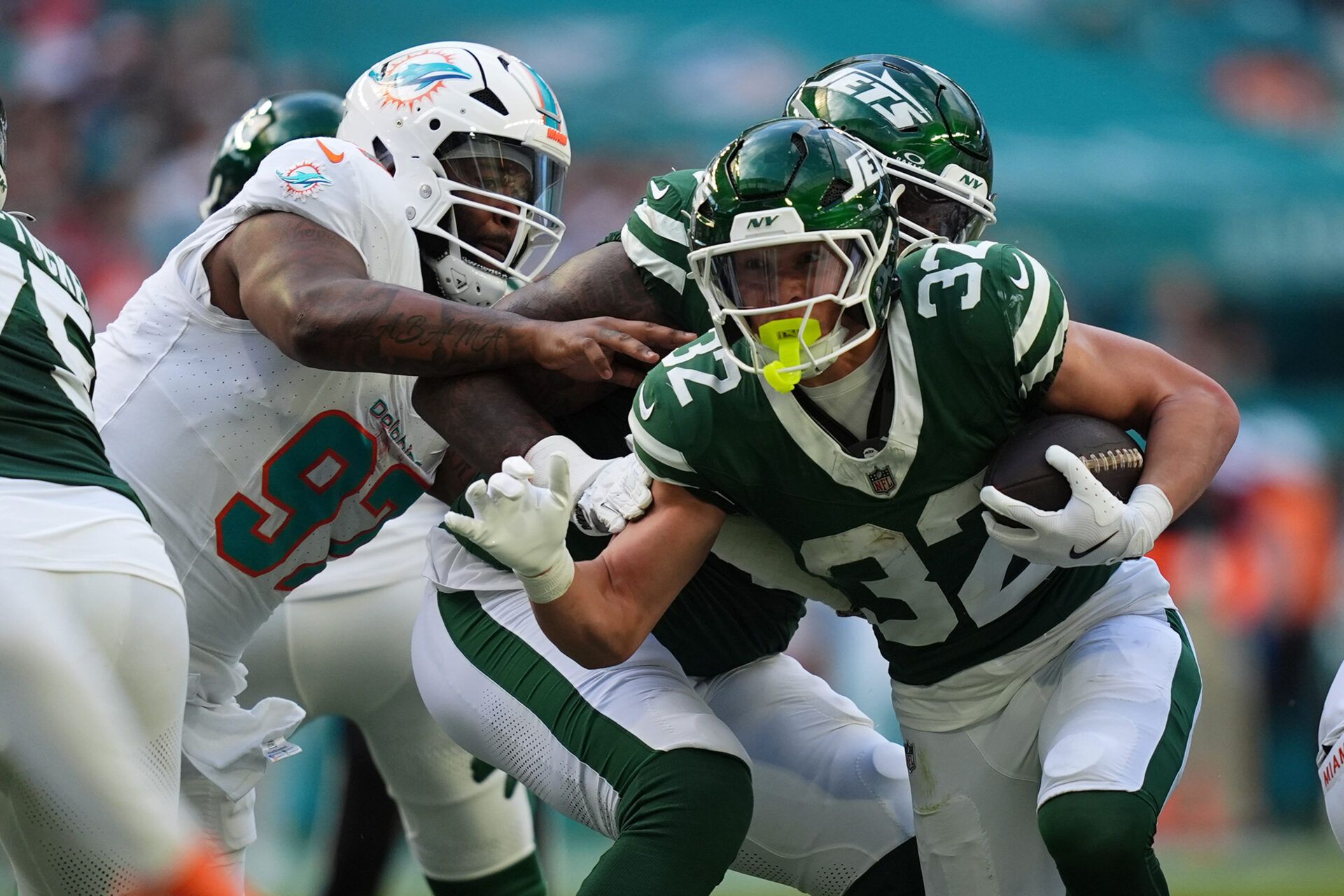 Dec 8, 2024; Miami Gardens, Florida, USA; New York Jets running back Isaiah Davis (32) rushes with the bal for a touchdown against the Miami Dolphins during the first half at Hard Rock Stadium. Mandatory Credit: Jasen Vinlove-Imagn Images