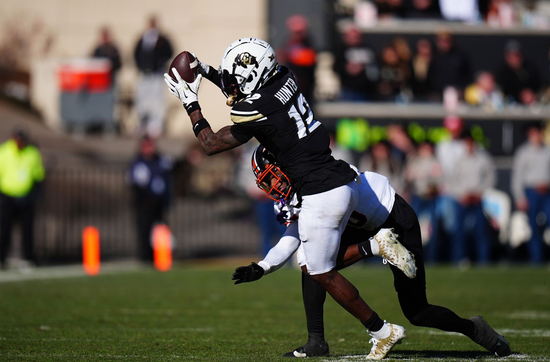 Oklahoma State Cowboys wide receiver Rashod Owens (10) defends on Colorado Buffaloes wide receiver Travis Hunter (12) in the second half at Folsom Field.