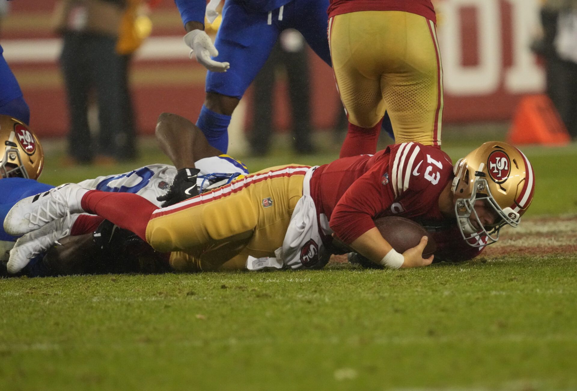 Dec 12, 2024; Santa Clara, California, USA; San Francisco 49ers quarterback Brock Purdy (13) is sacked on the final play against the Los Angeles Rams during the fourth quarter at Levi's Stadium. Mandatory Credit: Kelley L Cox-Imagn Images