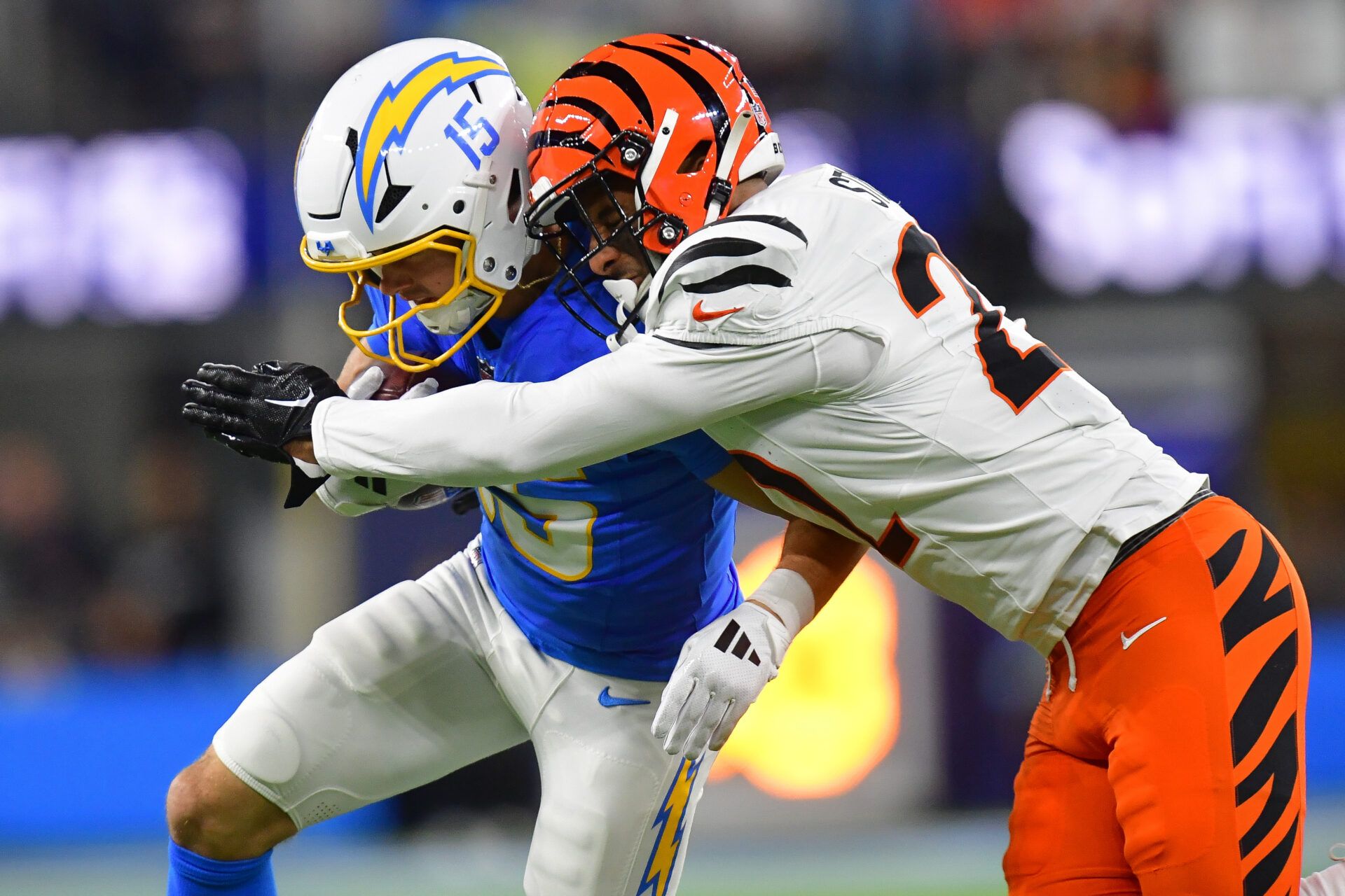 Nov 17, 2024; Inglewood, California, USA; Los Angeles Chargers wide receiver Ladd McConkey (15) runs the ball against Cincinnati Bengals safety Geno Stone (22) during the first half at SoFi Stadium. Mandatory Credit: Gary A. Vasquez-Imagn Images