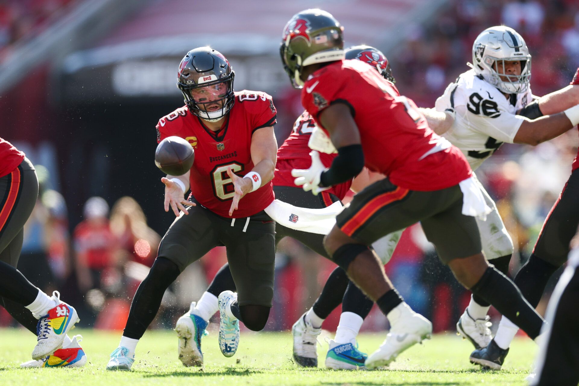 Dec 8, 2024; Tampa, Florida, USA; Tampa Bay Buccaneers quarterback Baker Mayfield (6) hands off to running back Rachaad White (1) against the Las Vegas Raiders in the second quarter at Raymond James Stadium. Mandatory Credit: Nathan Ray Seebeck-Imagn Images