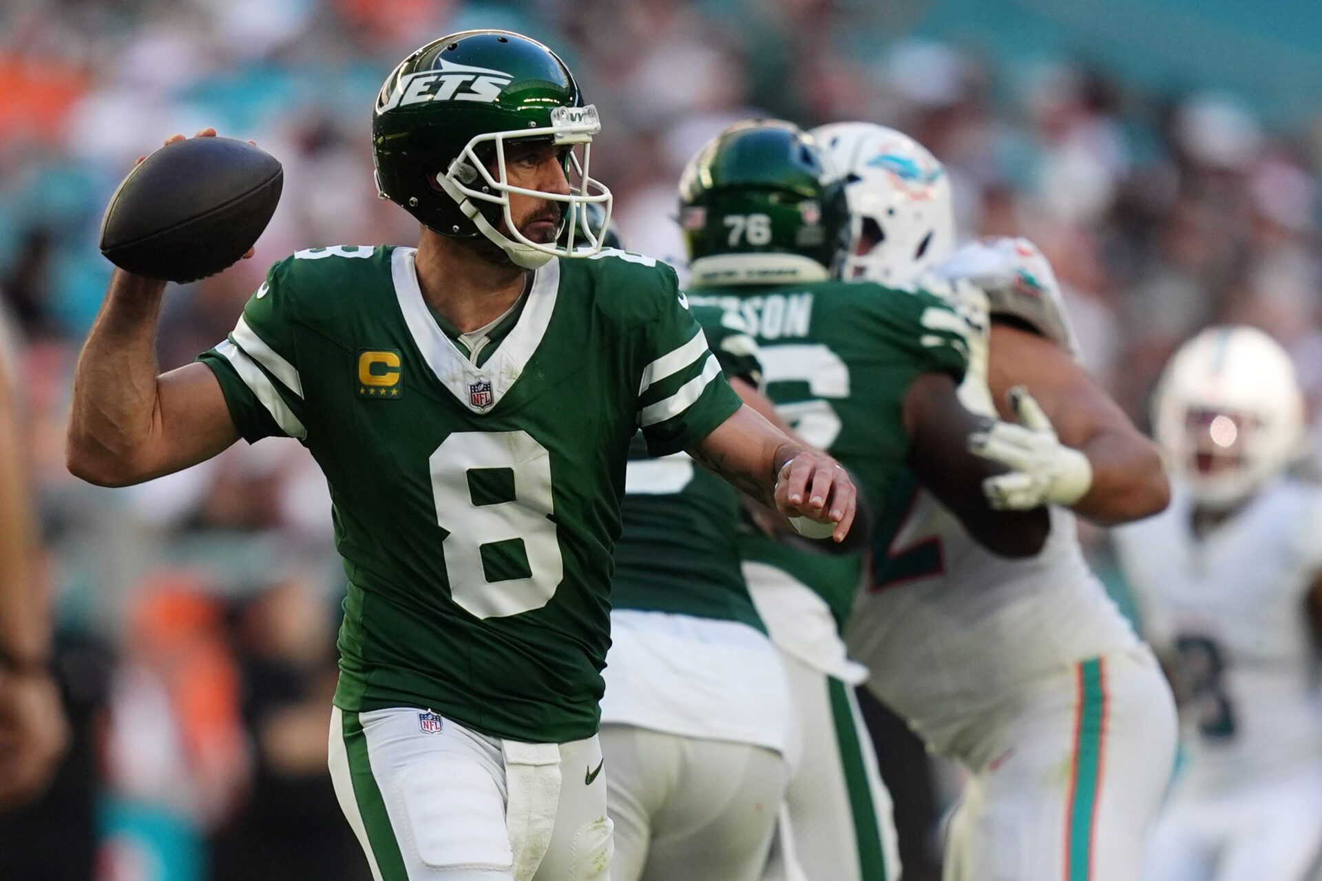 Dec 8, 2024; Miami Gardens, Florida, USA; New York Jets quarterback Aaron Rodgers (8) attempts a pass against the Miami Dolphins during the second half at Hard Rock Stadium. Mandatory Credit: Jasen Vinlove-Imagn Images