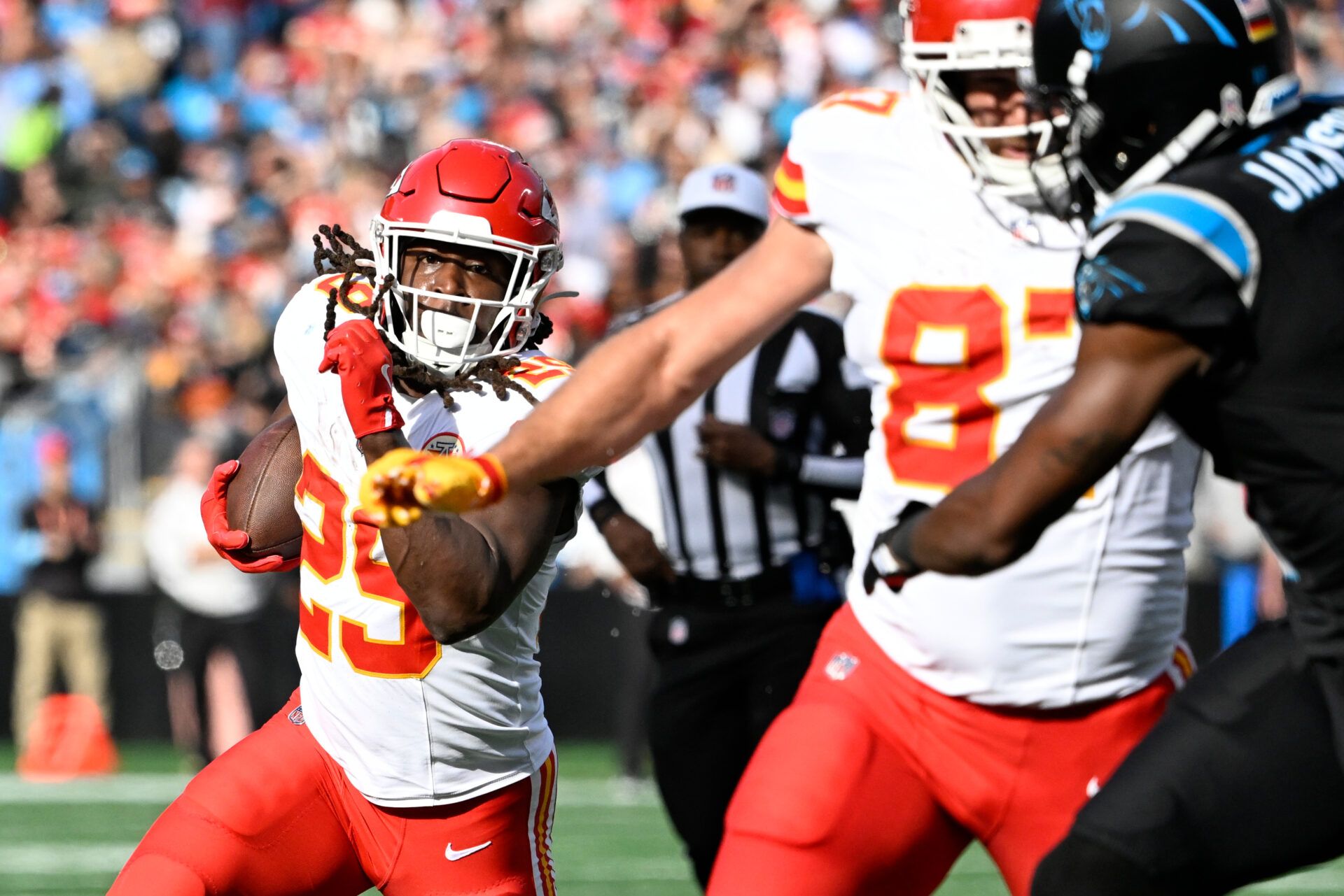 Nov 24, 2024; Charlotte, North Carolina, USA; Kansas City Chiefs running back Kareem Hunt (29) runs as tight end Travis Kelce (87) blocks and Carolina Panthers cornerback Michael Jackson (2) defends in the second quarter at Bank of America Stadium. Mandatory Credit: Bob Donnan-Imagn Images